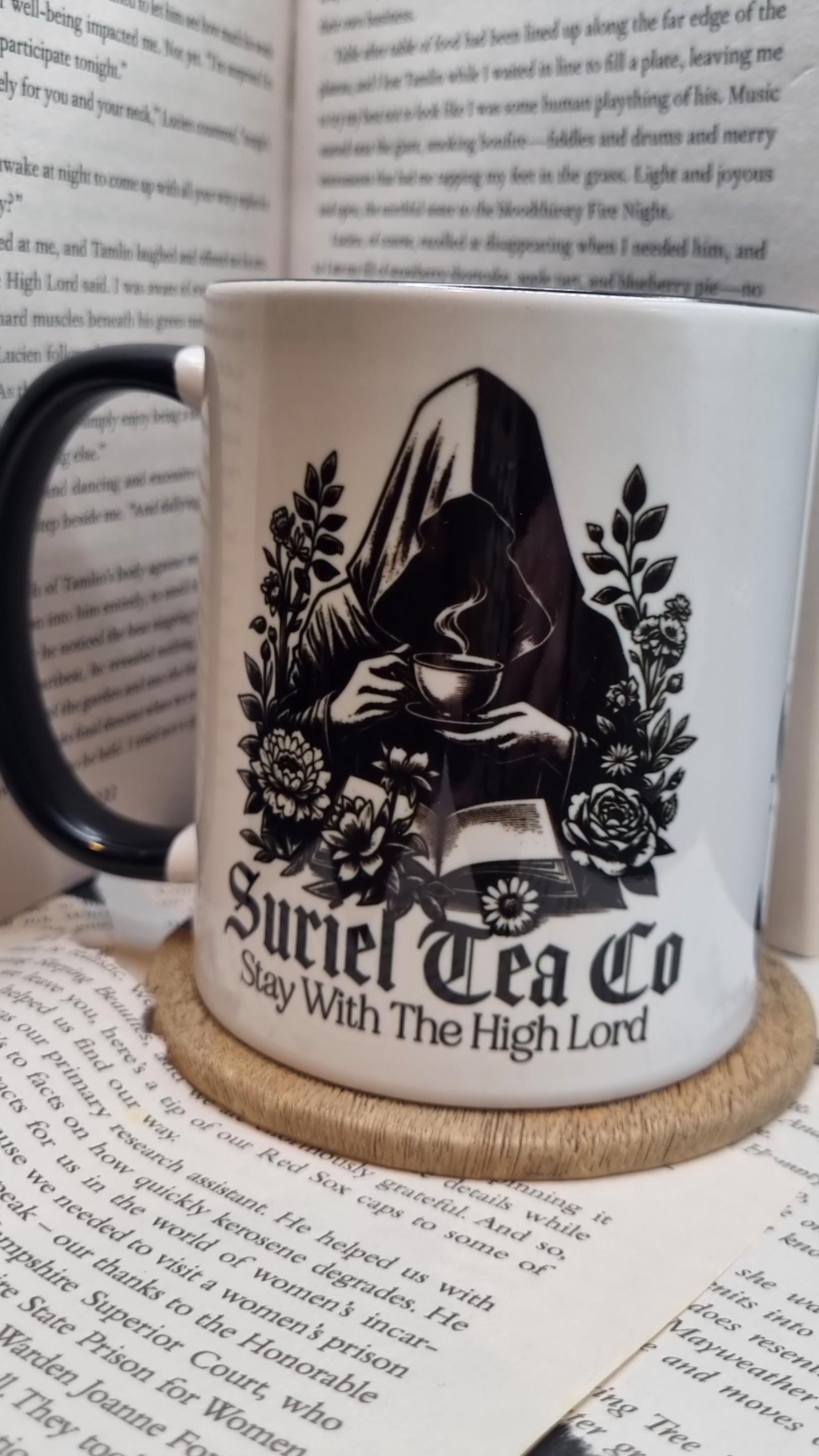Acotar themed mug gift with Suriel Tea Co design featuring a cloaked figure holding a teacup and floral details