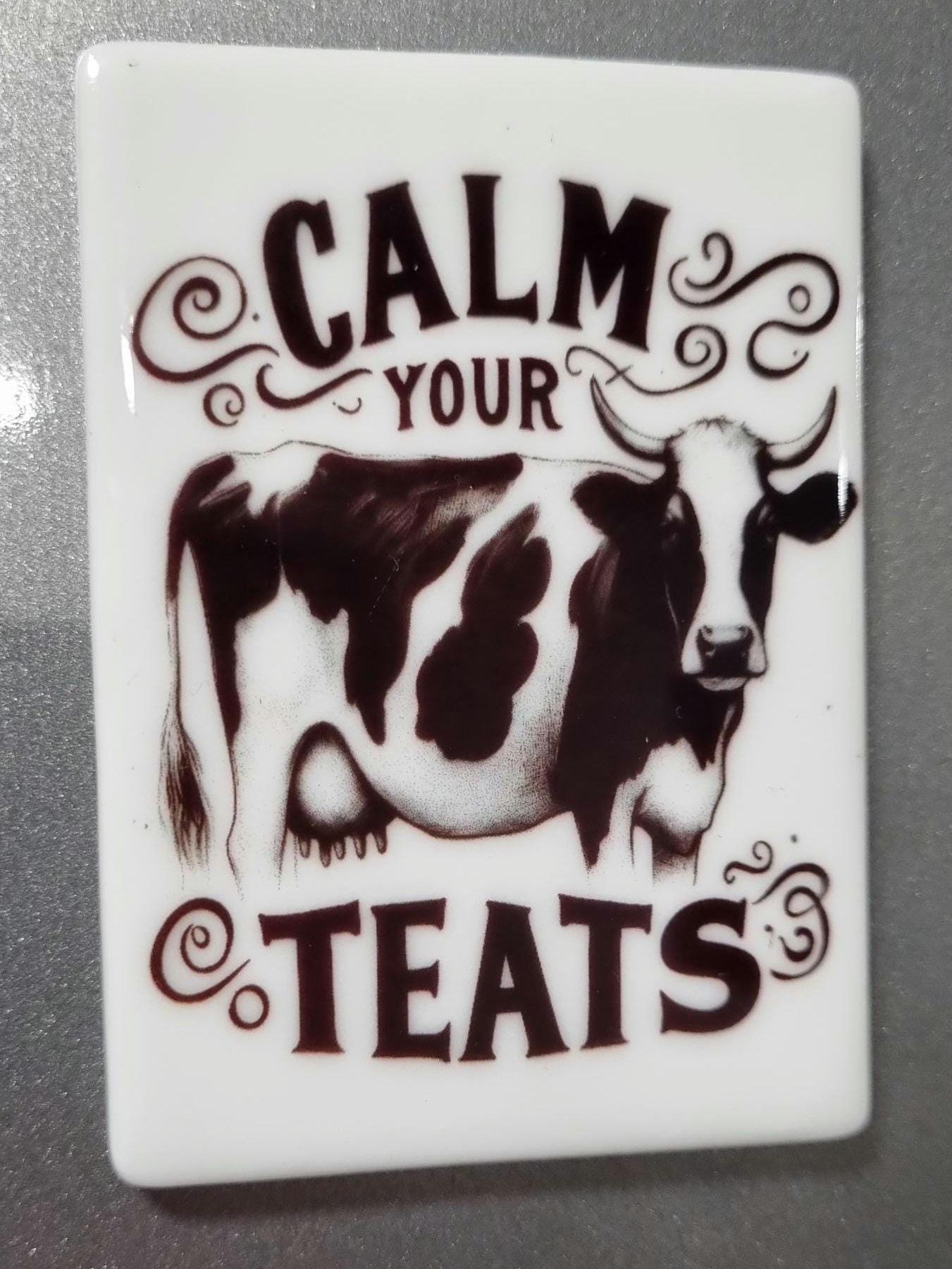 Calm your teats novelty magnet featuring a black and white cow illustration on white background