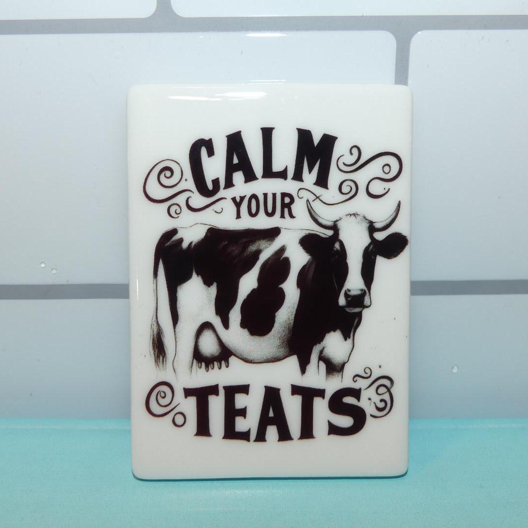 Calm your teats novelty magnet with black and white cow illustration on white background