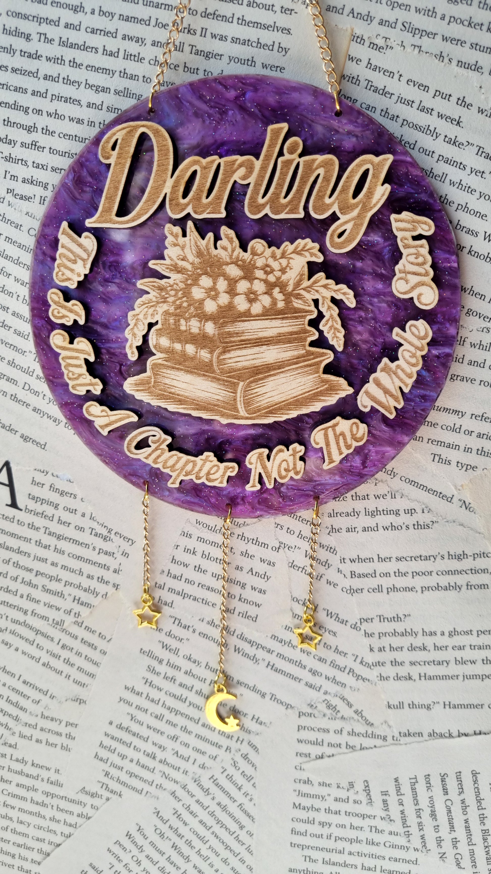 Just a chapter bookish ornament with stacked books and flowers on a purple background by Sublimely Special