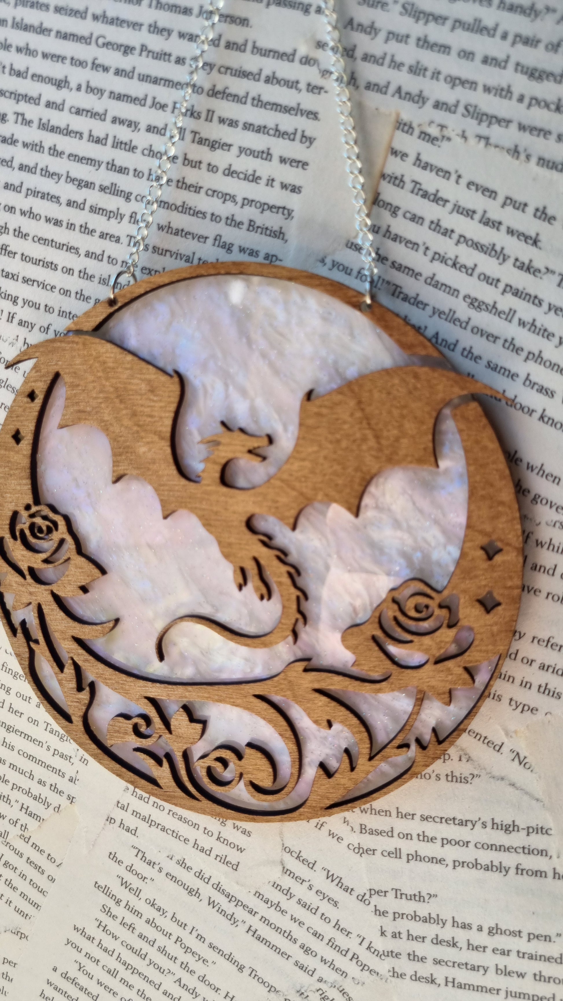 Whimsical dragon ornament for bookshelf made of carved wood with floral patterns and round shape