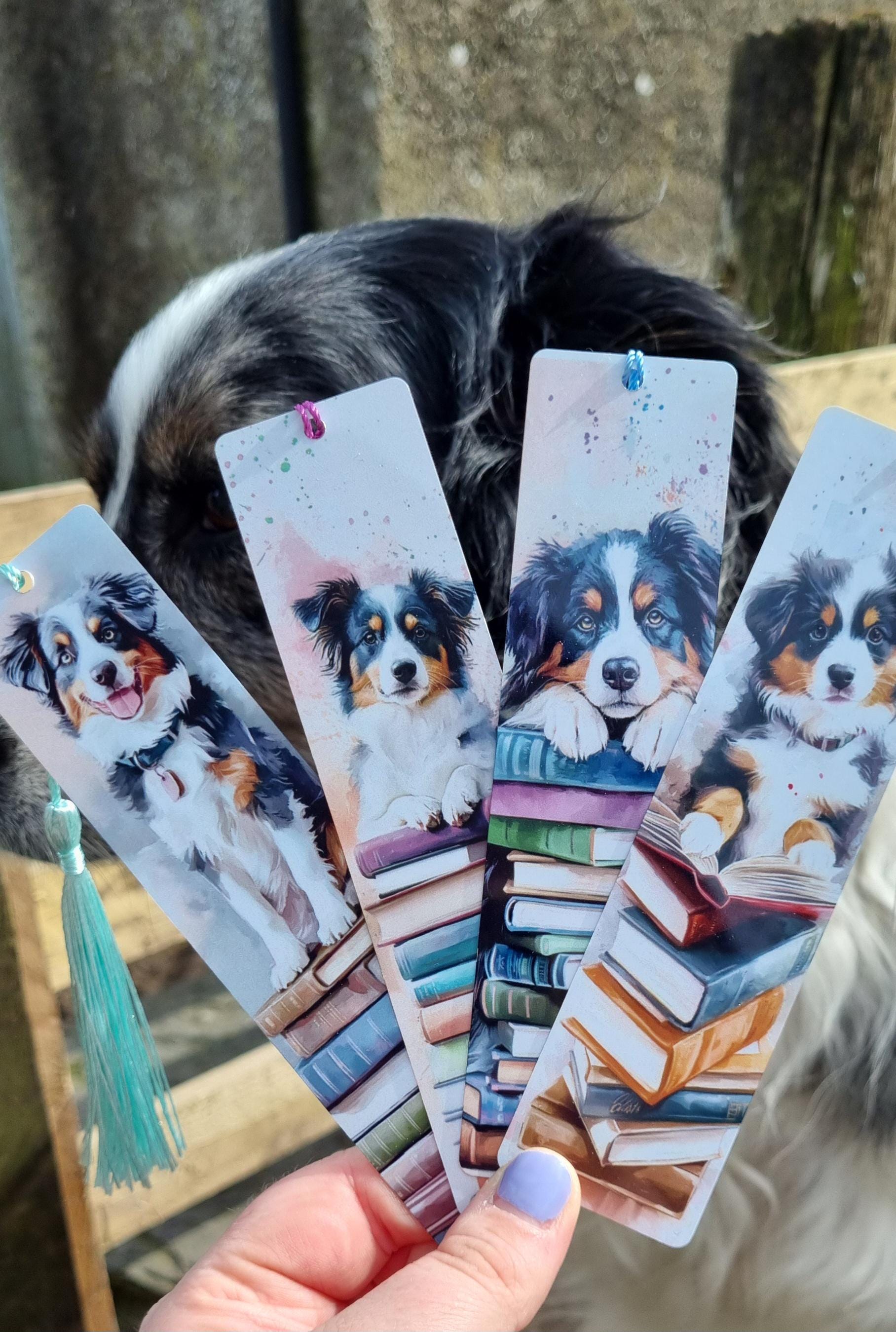 Set of dog lover gifts for readers featuring bookmarks with Australian Shepherd dog illustrations and stacks of books