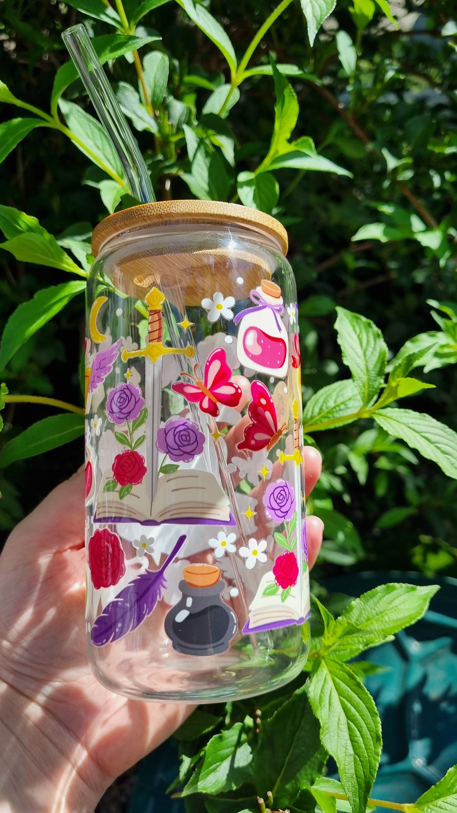 Dragon bookish glass tumbler decorated with fantasy-themed illustrations including books, flowers, and potions