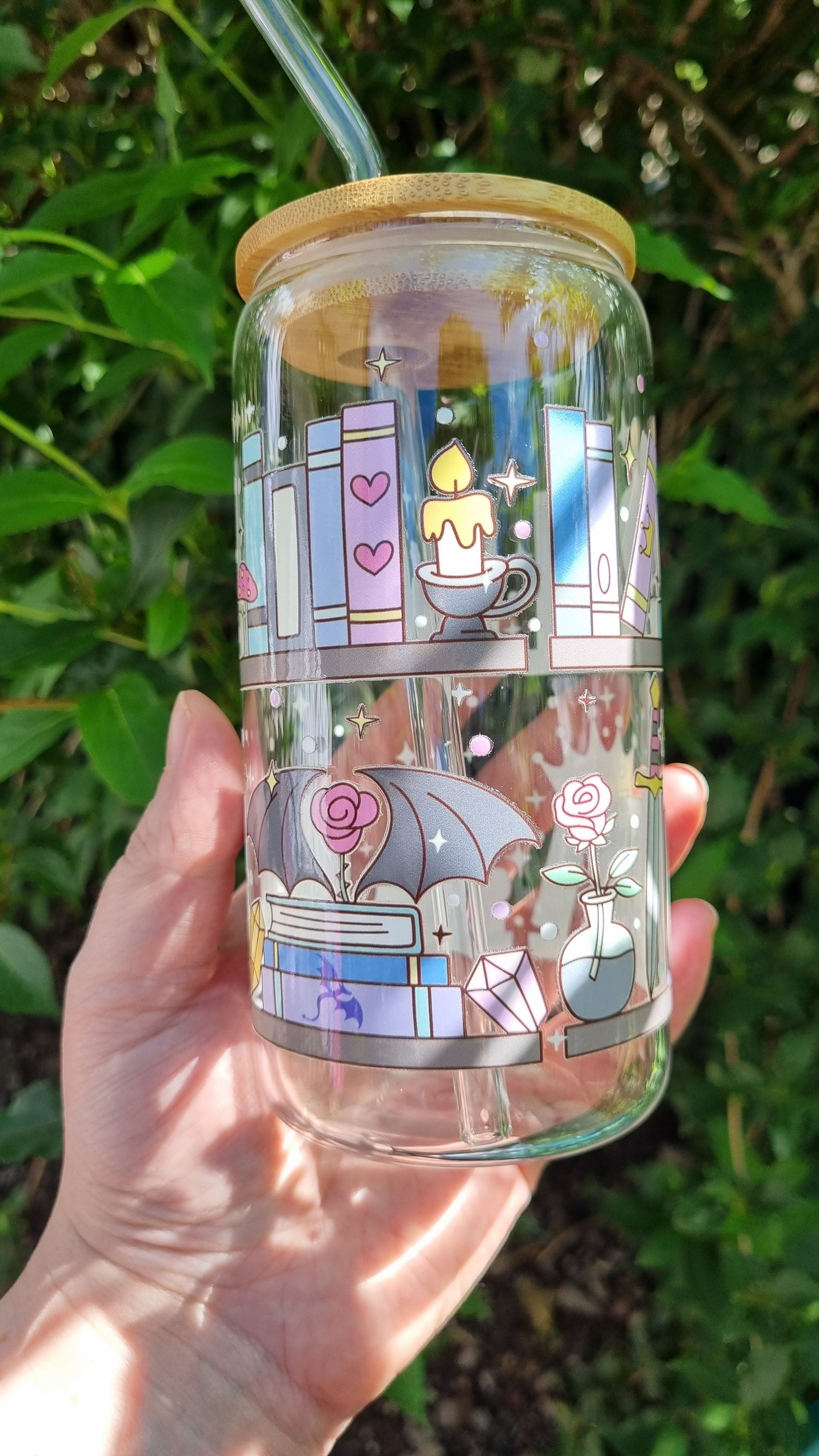 Sublimely Special fantasy bookshelf glass tumbler with wooden lid and straw held outdoors
