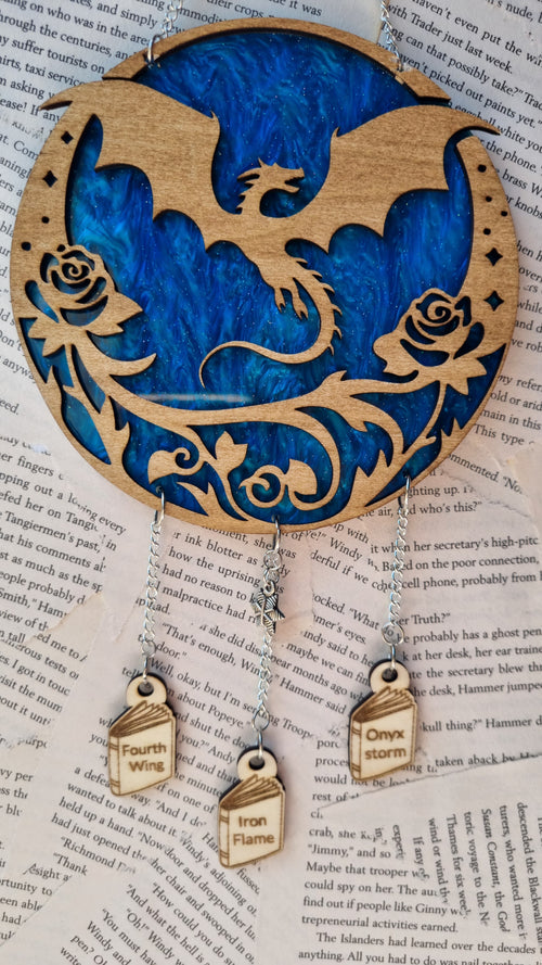 Fourth Wing inspired ornament wooden dragon design with roses and hanging tags on blue background