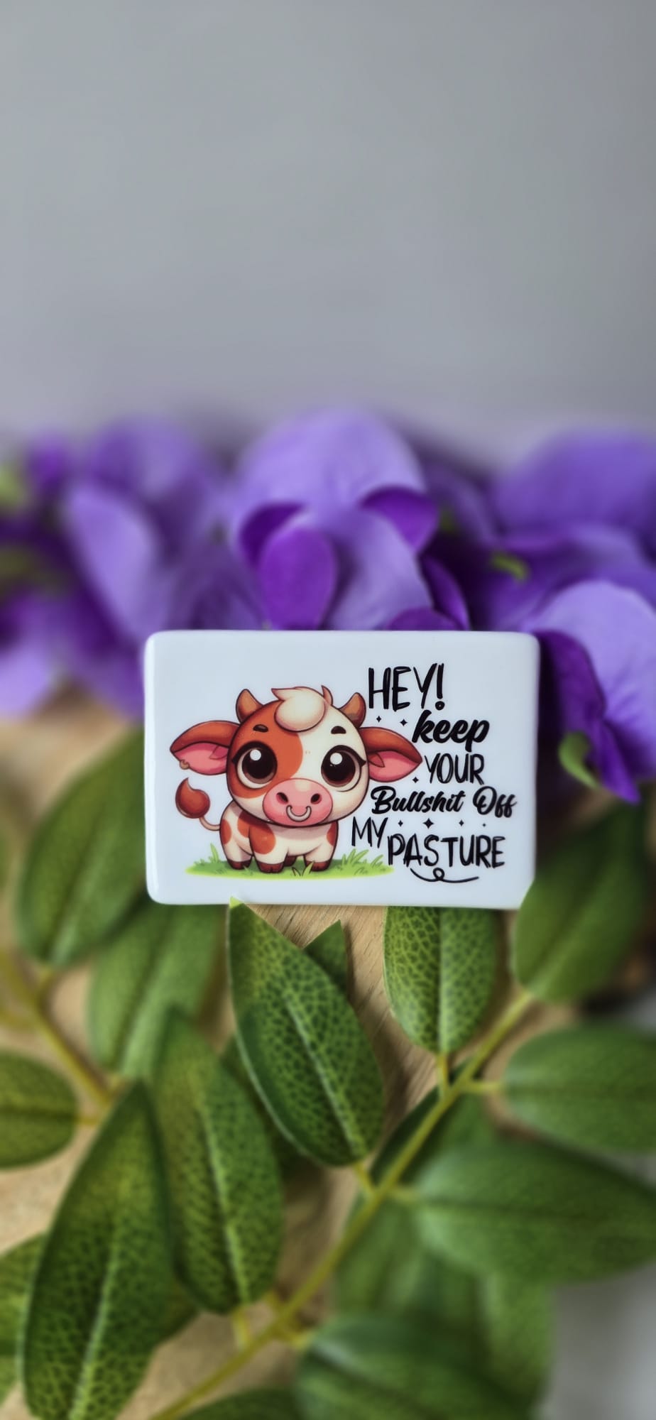 Funny cow fridge magnet with cartoon cow and humorous text keep your bullshit off my pasture