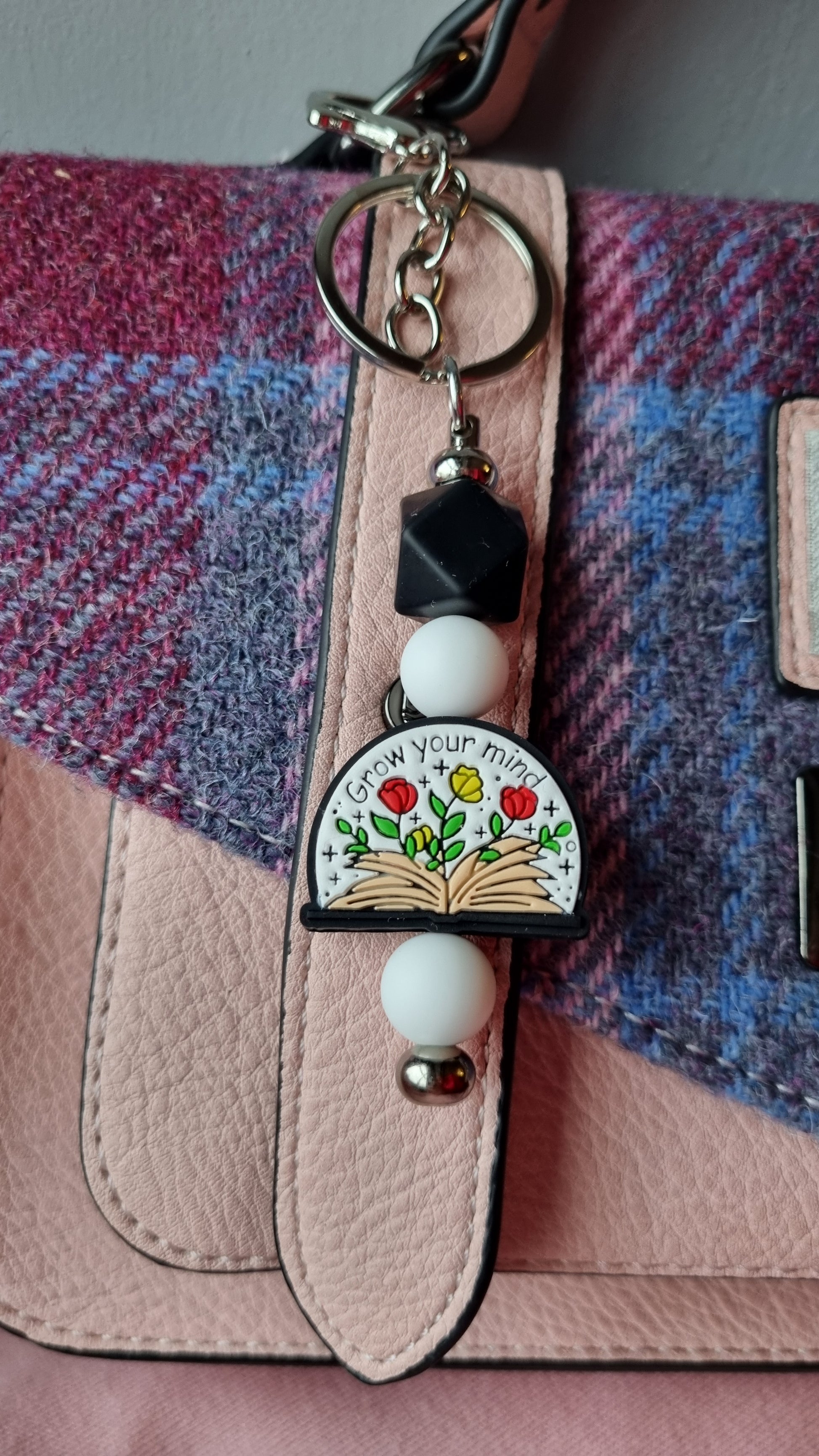 Sublimely Special grow your mind keychain with colourful flower design attached to a pink and purple bag
