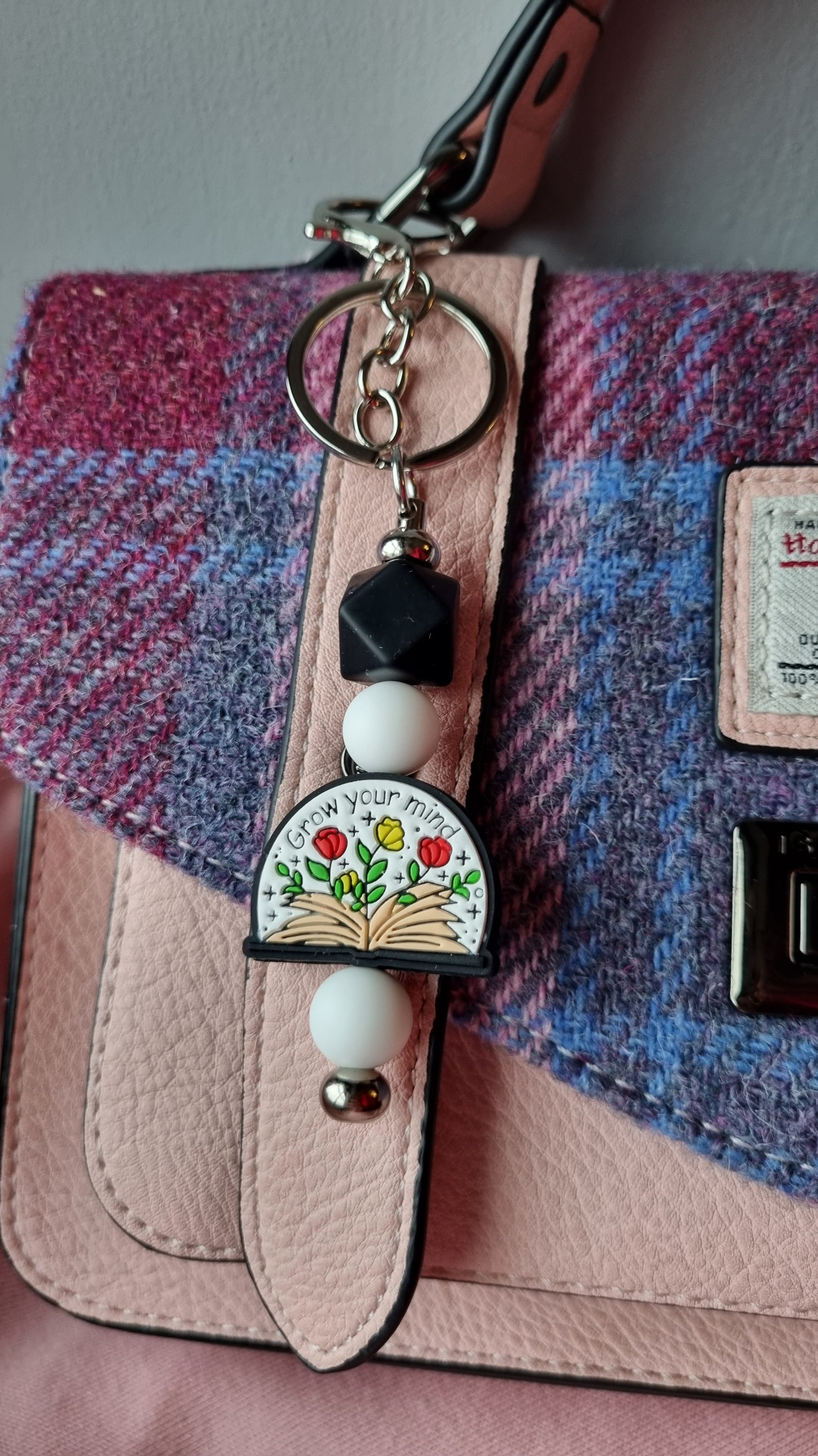 Sublimely Special grow your mind keychain with floral design and beads attached to pink and purple handbag