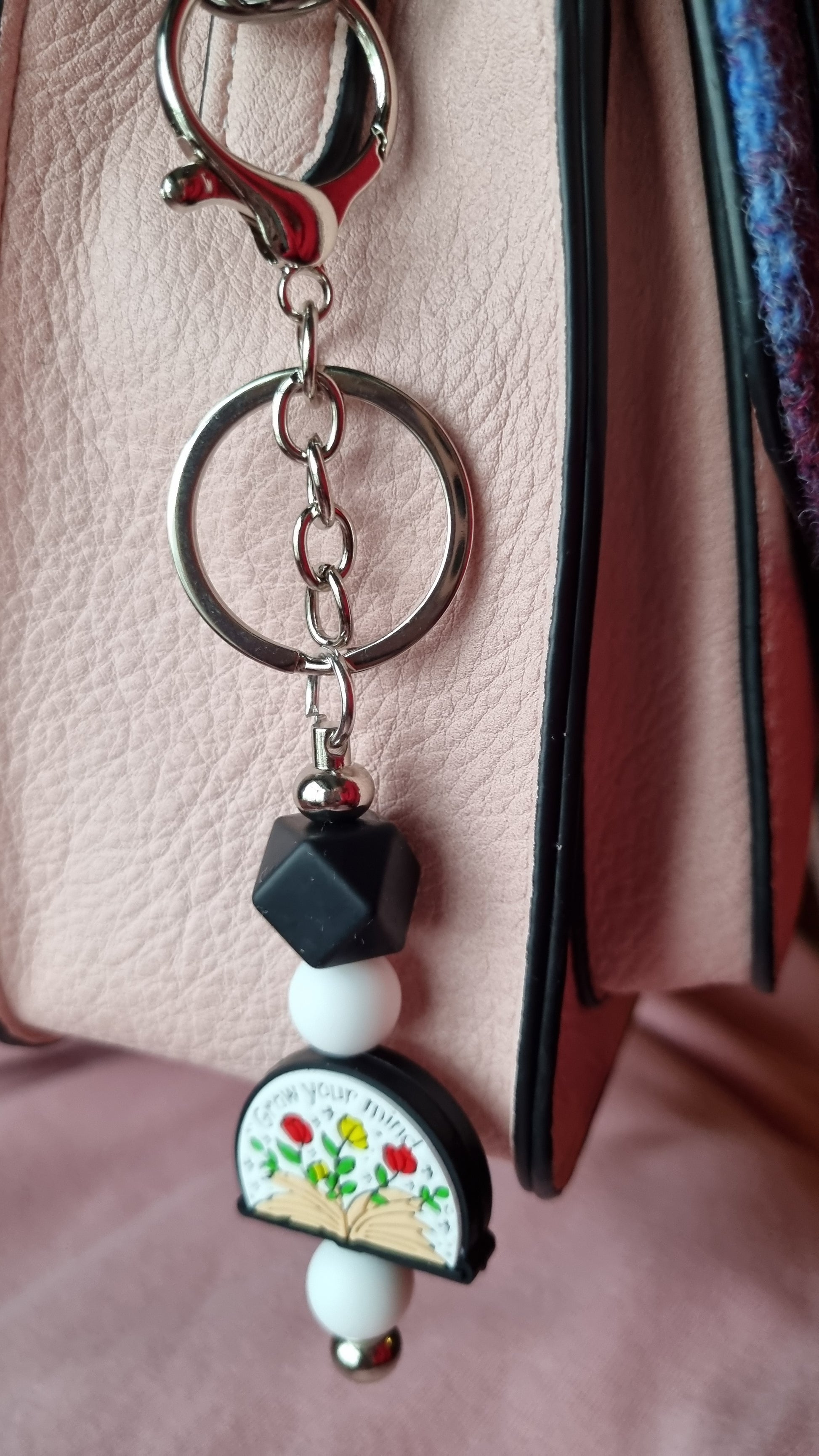 Sublimely Special grow your mind keychain with floral and geometric bead design hanging from bag