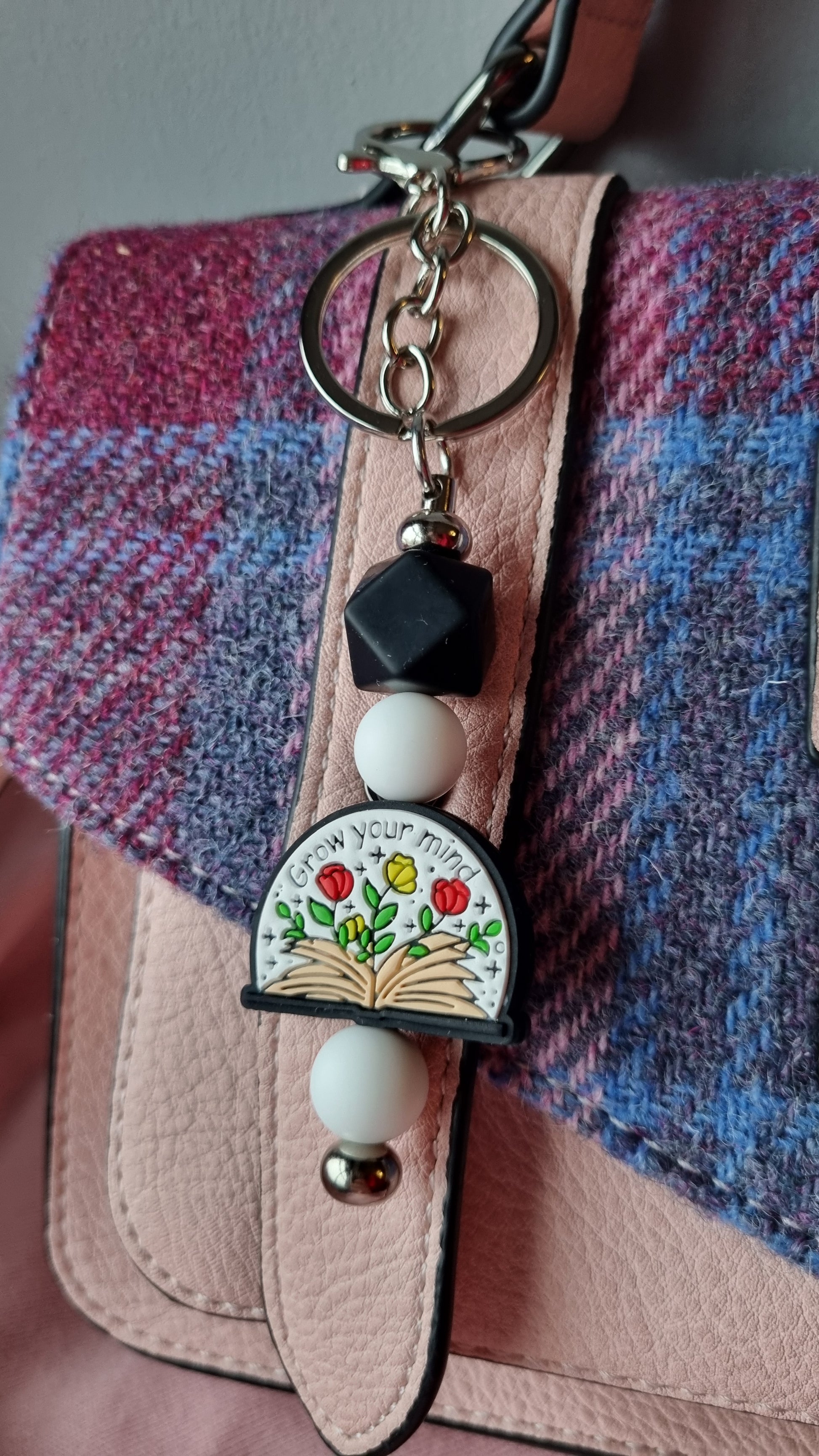 Sublimely Special grow your mind keychain with colourful flowers and beads hanging on a pink bag strap