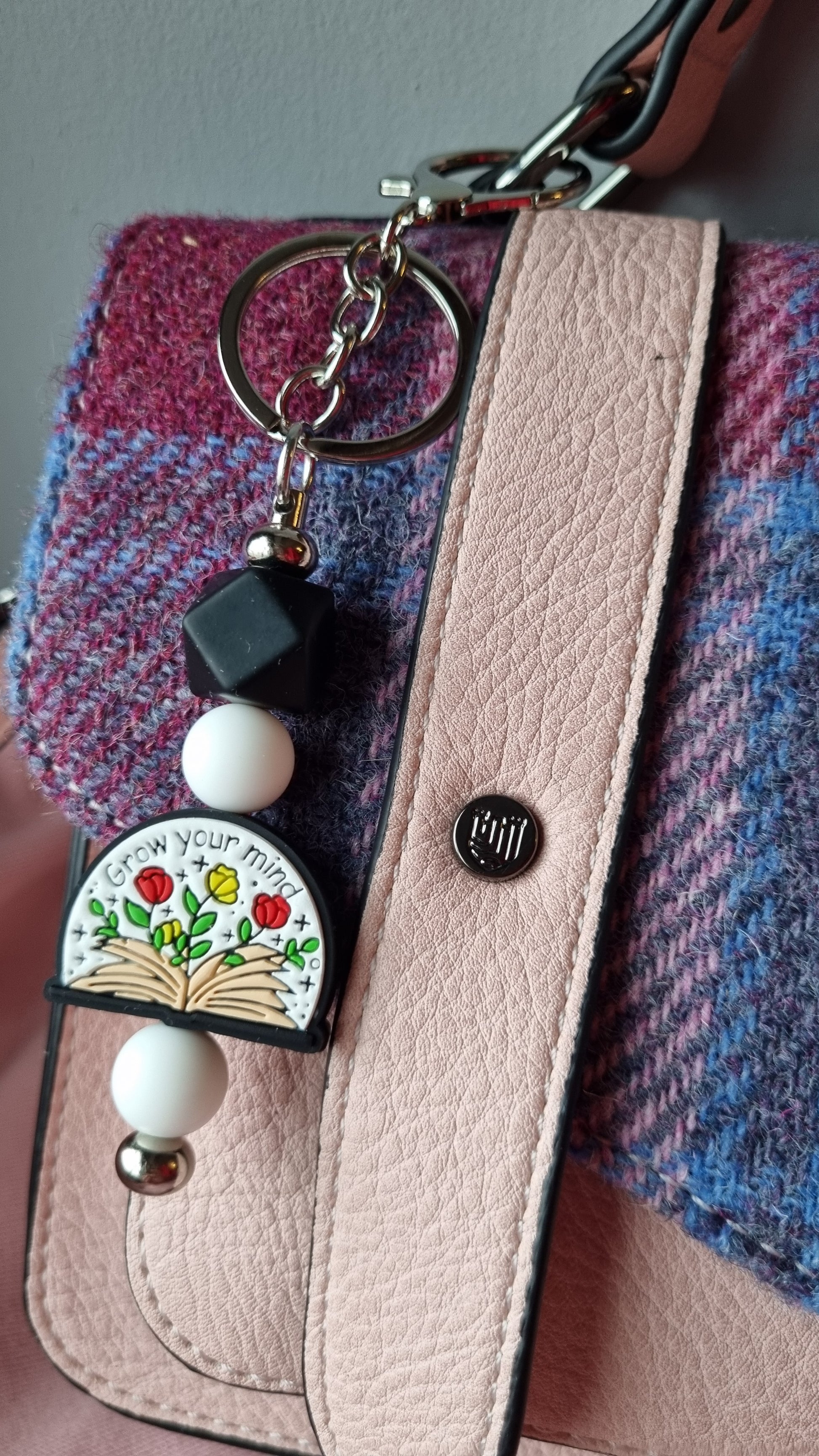 Sublimely Special grow your mind keychain with colourful flower design attached to pink leather bag