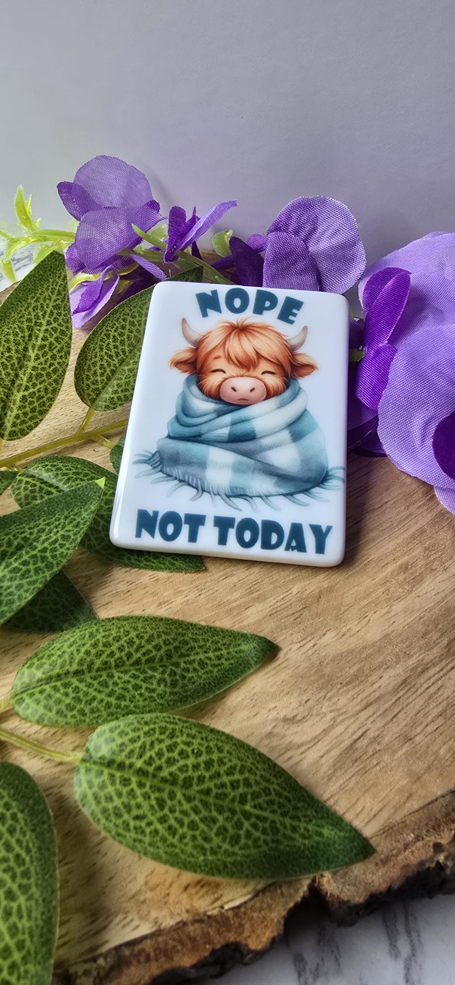 Highland cow fridge magnet with cute sleeping cow wrapped in blue blanket and text nope not today