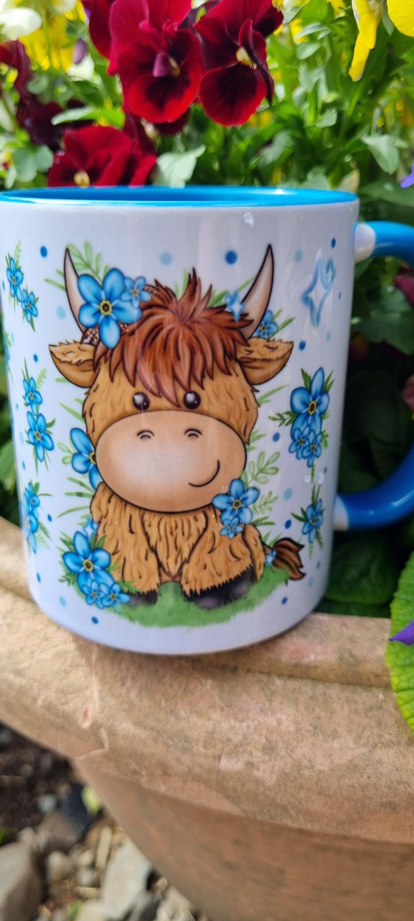 Cute ceramic mug with highland cow gift for animal lovers design featuring blue flowers and cartoon cow