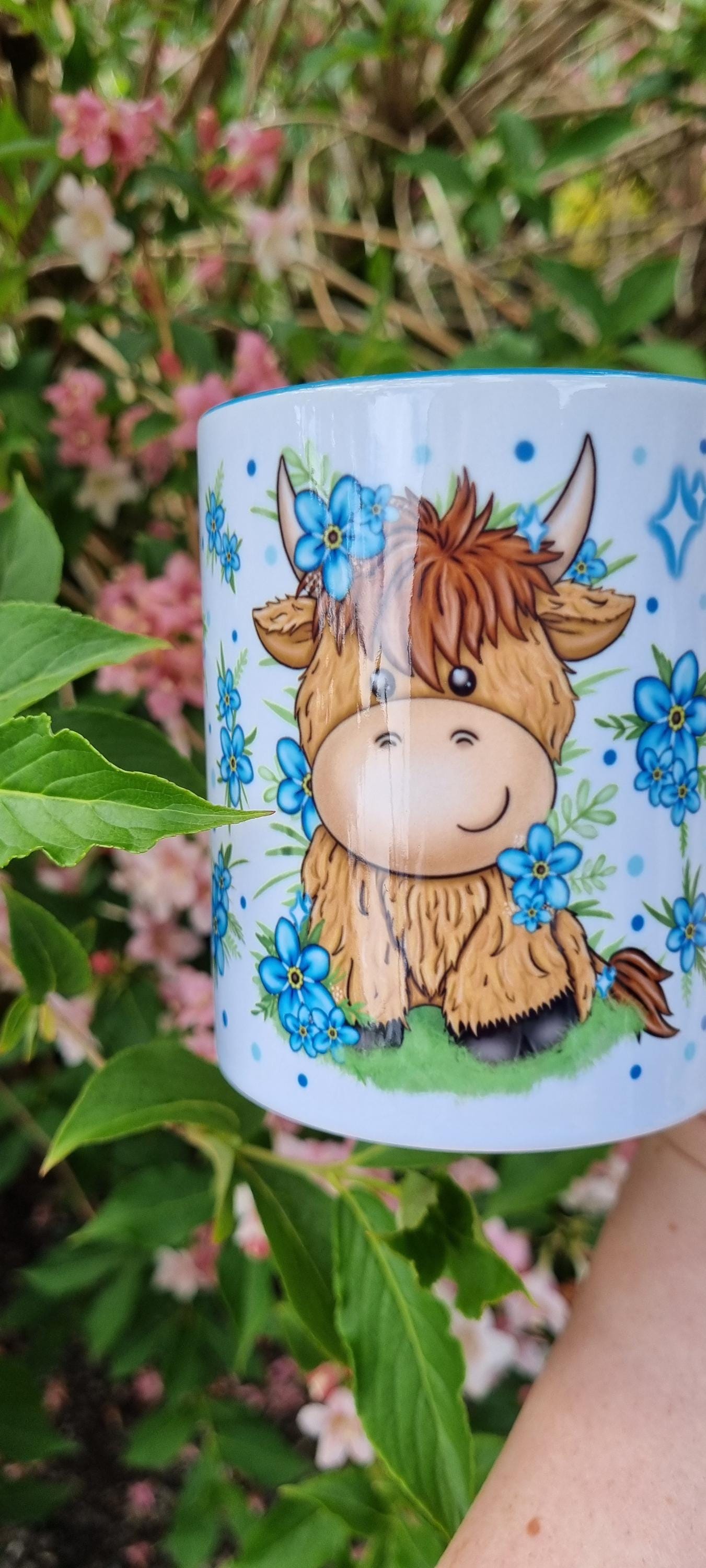 Cute cartoon highland cow mug with blue flowers, perfect highland cow gift for animal lovers
