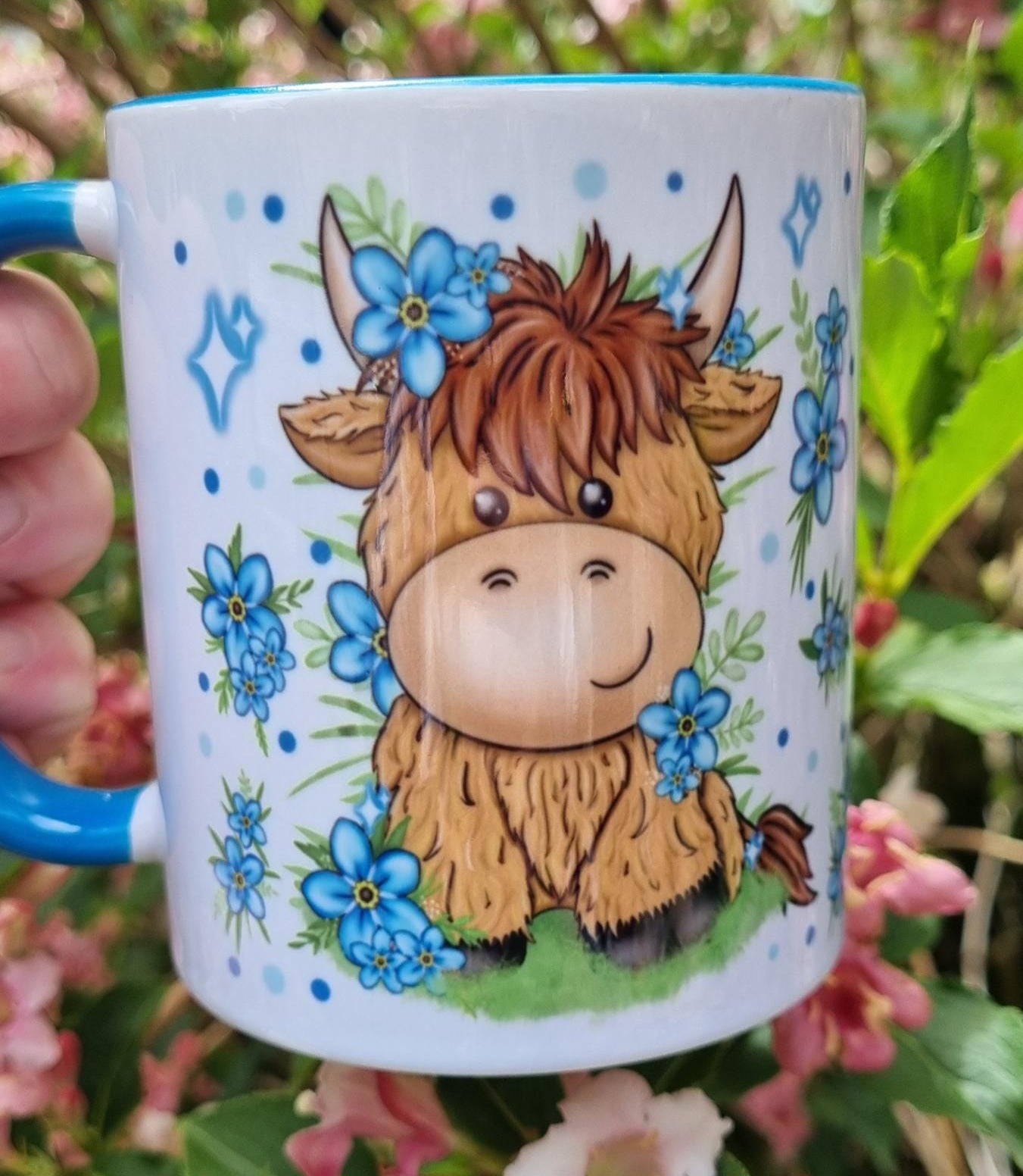 Cute highland cow gift for animal lovers ceramic mug with blue floral design and blue handle