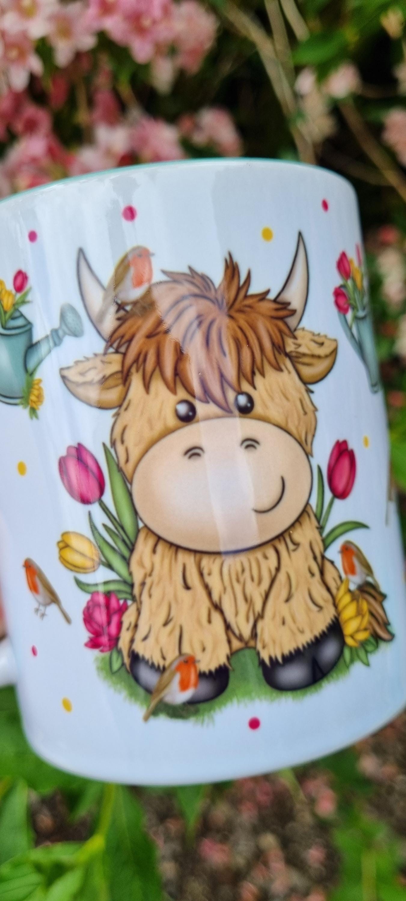 Cute illustrated highland cow mug surrounded by flowers and birds, perfect highland cow gift for animal lovers