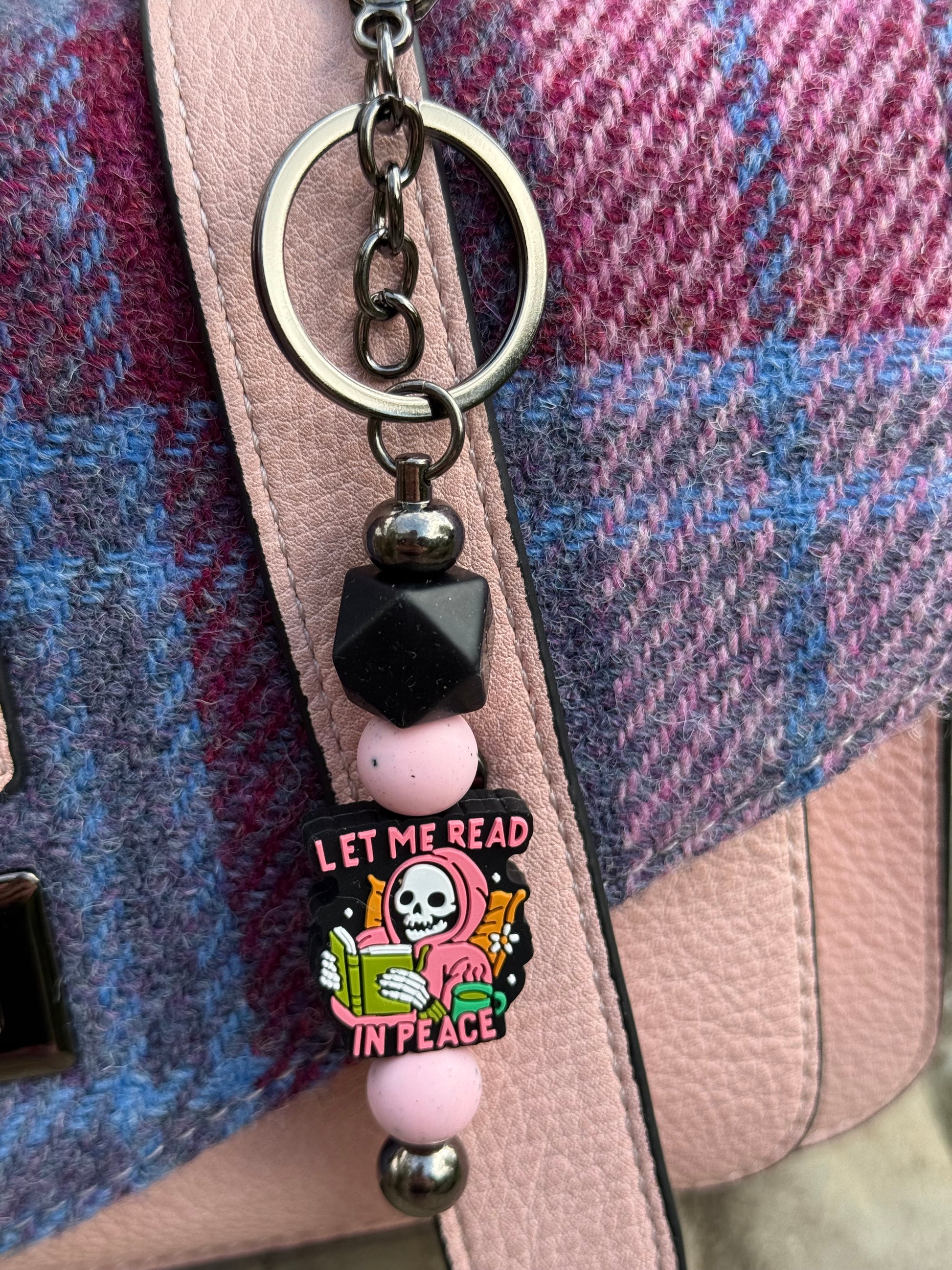 Sublimely Special let me read in peace keyring with skull design and pink beads attached to handbag