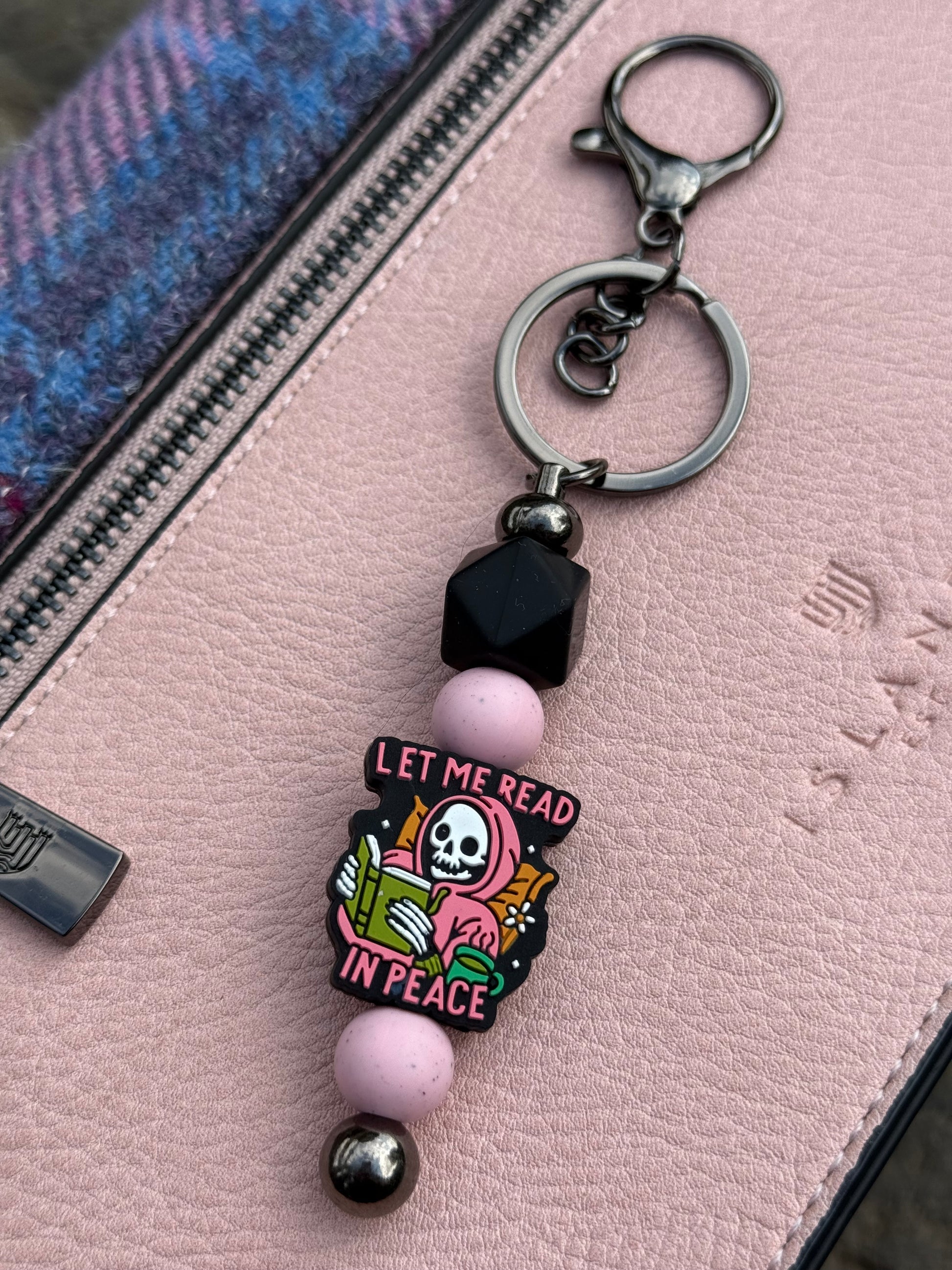 Sublimely Special let me read in peace keyring with pink beads and skeleton reading a book charm