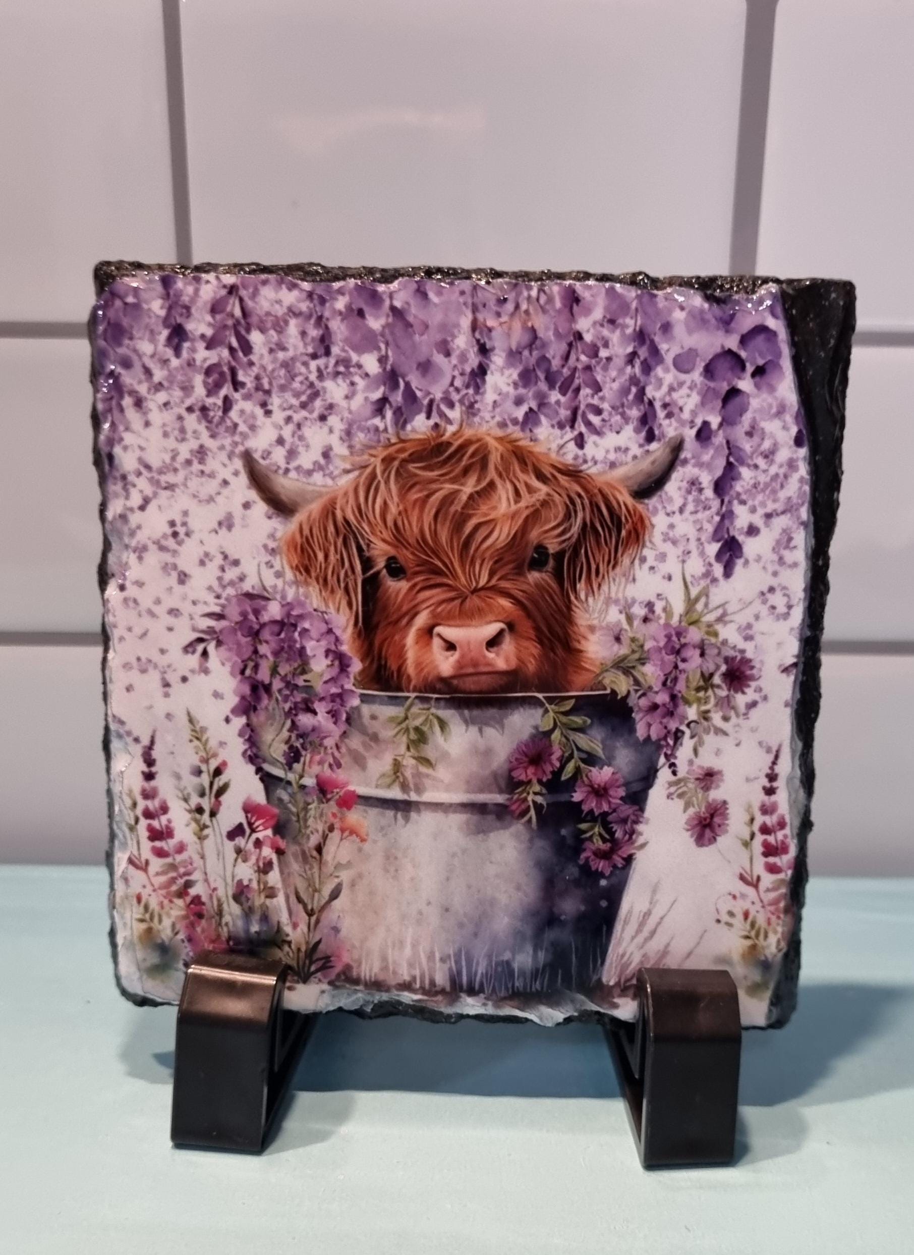 Lilac highland cow coaster featuring a cute brown cow with lilac flowers in a rustic design