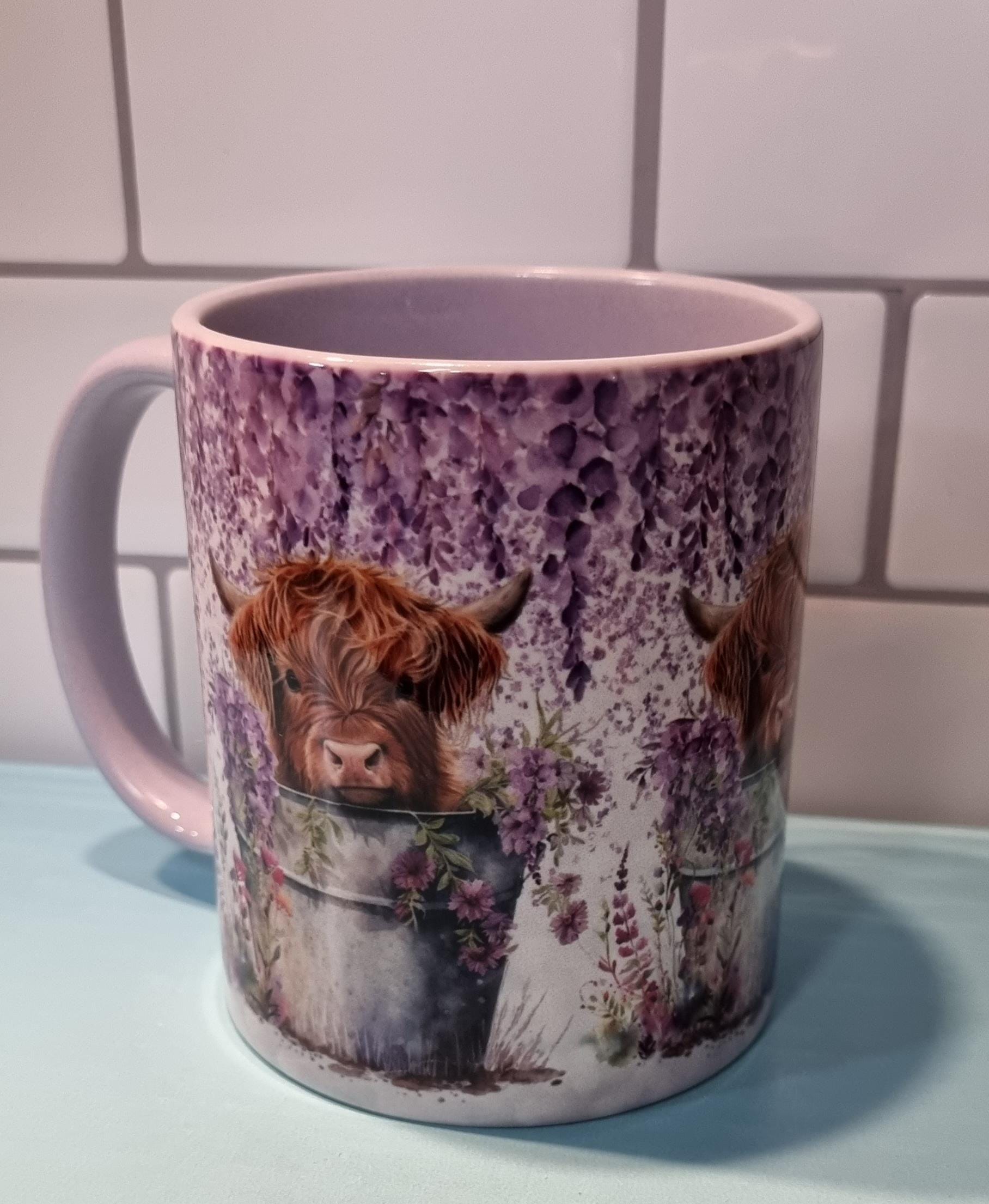 Lilac highland cow mug with detailed purple floral design and brown highland cow illustration