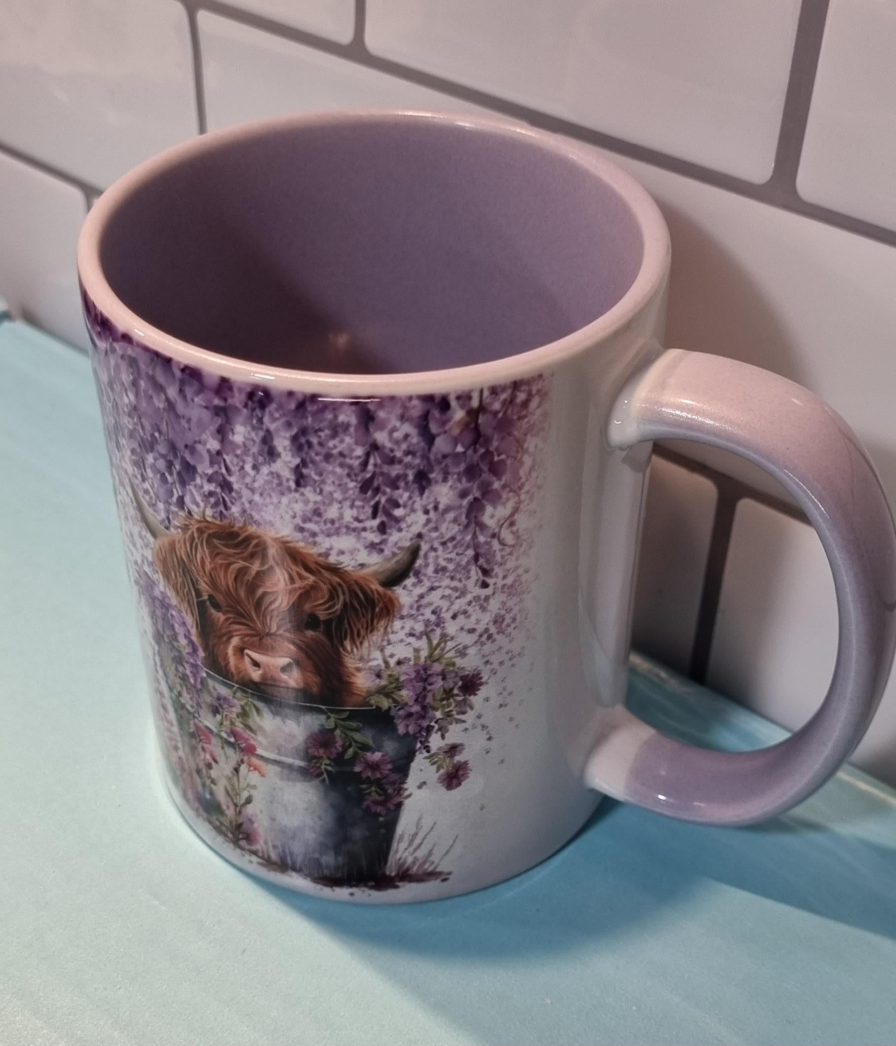 Lilac highland cow mug with floral design and lilac interior and handle