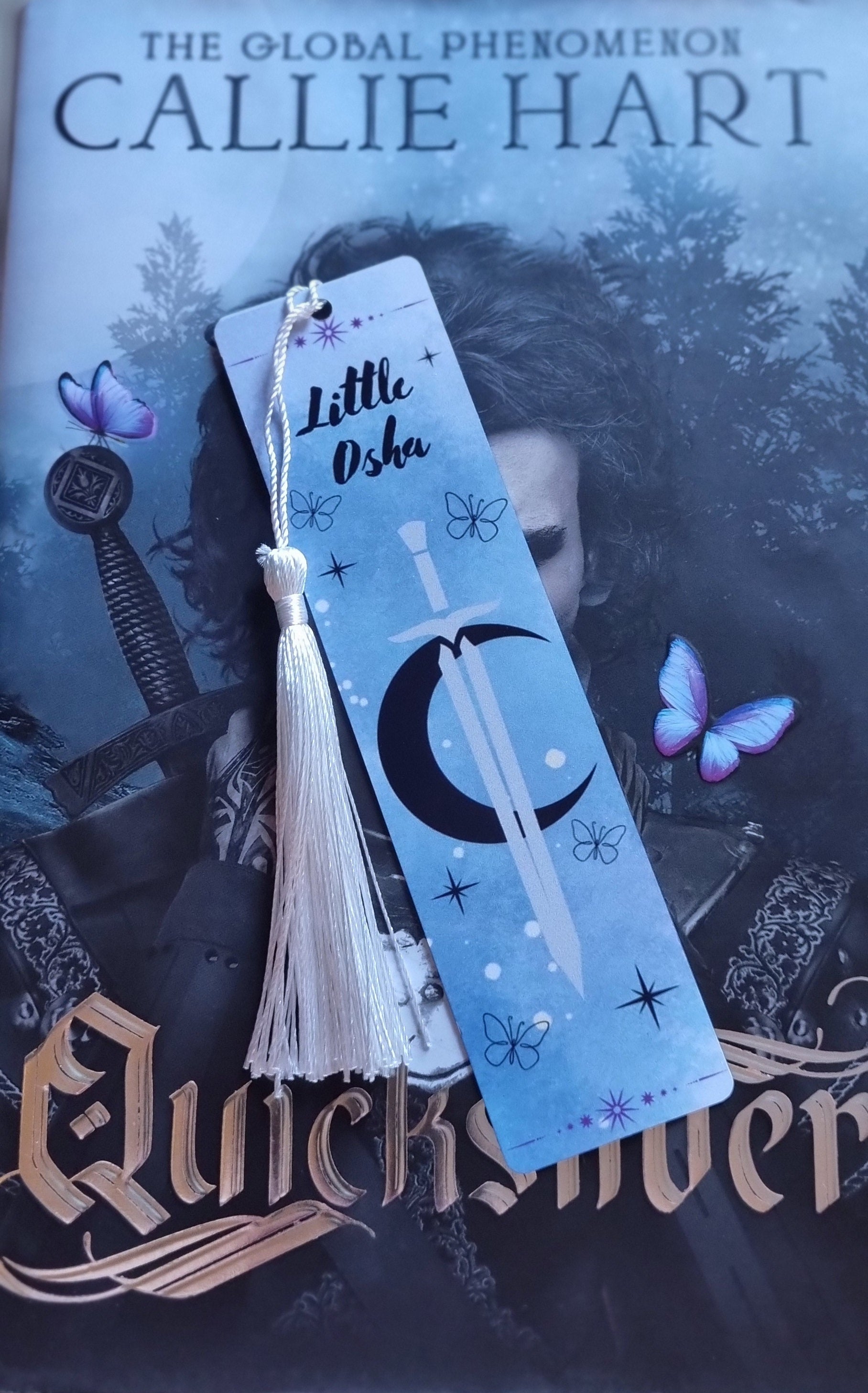 Little Osha book gift blue bookmark with tassel and butterflies on a fantasy novel by Callie Hart