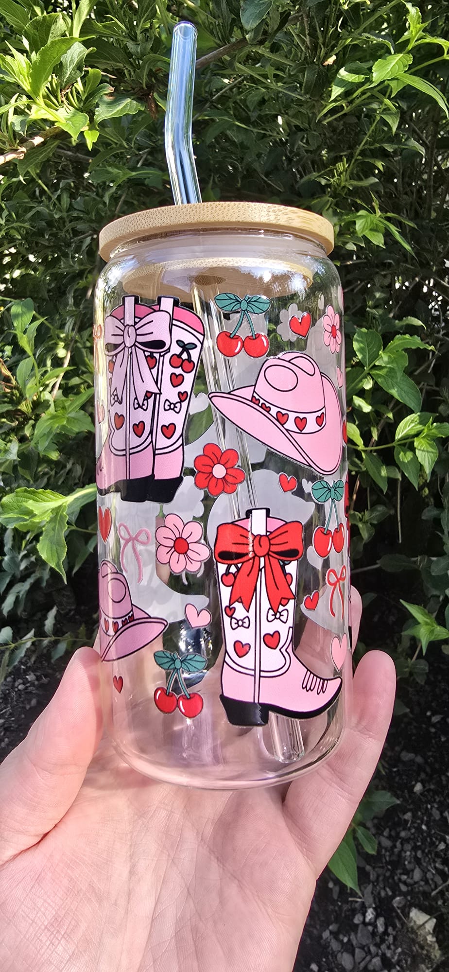 Sublimely Special pink cowgirl glass tumbler with straw featuring cowboy boots, hats, cherries, and flowers design