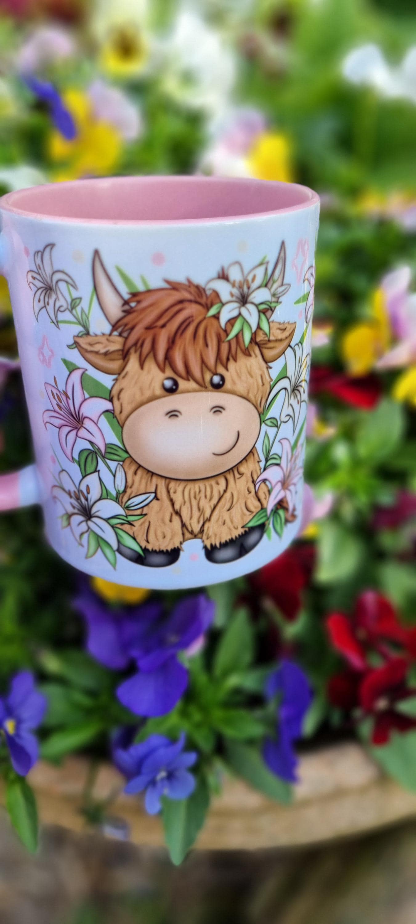 Pink highland cow mug with cute cow illustration and floral design on the outside
