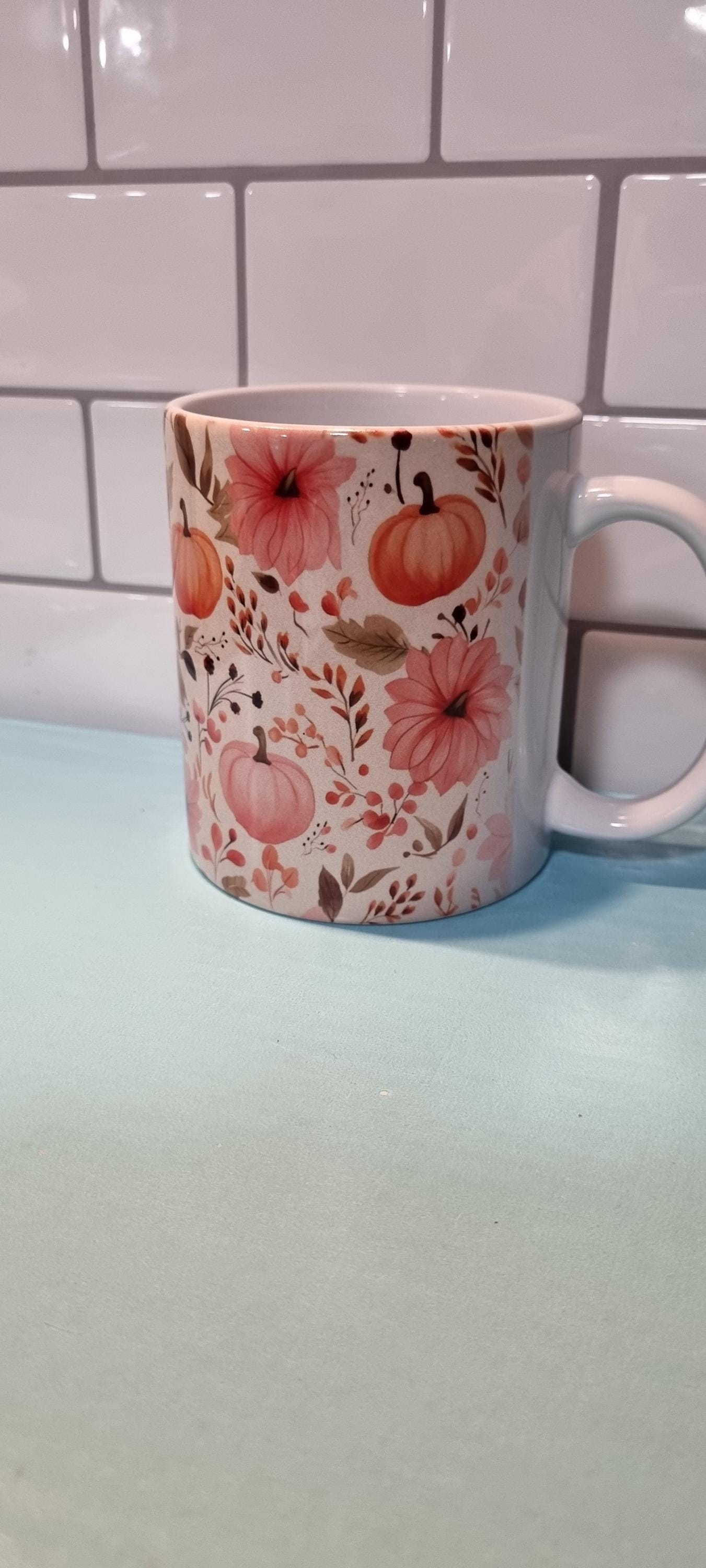 pumpkin and flowers mug with orange pumpkins and pink floral design
