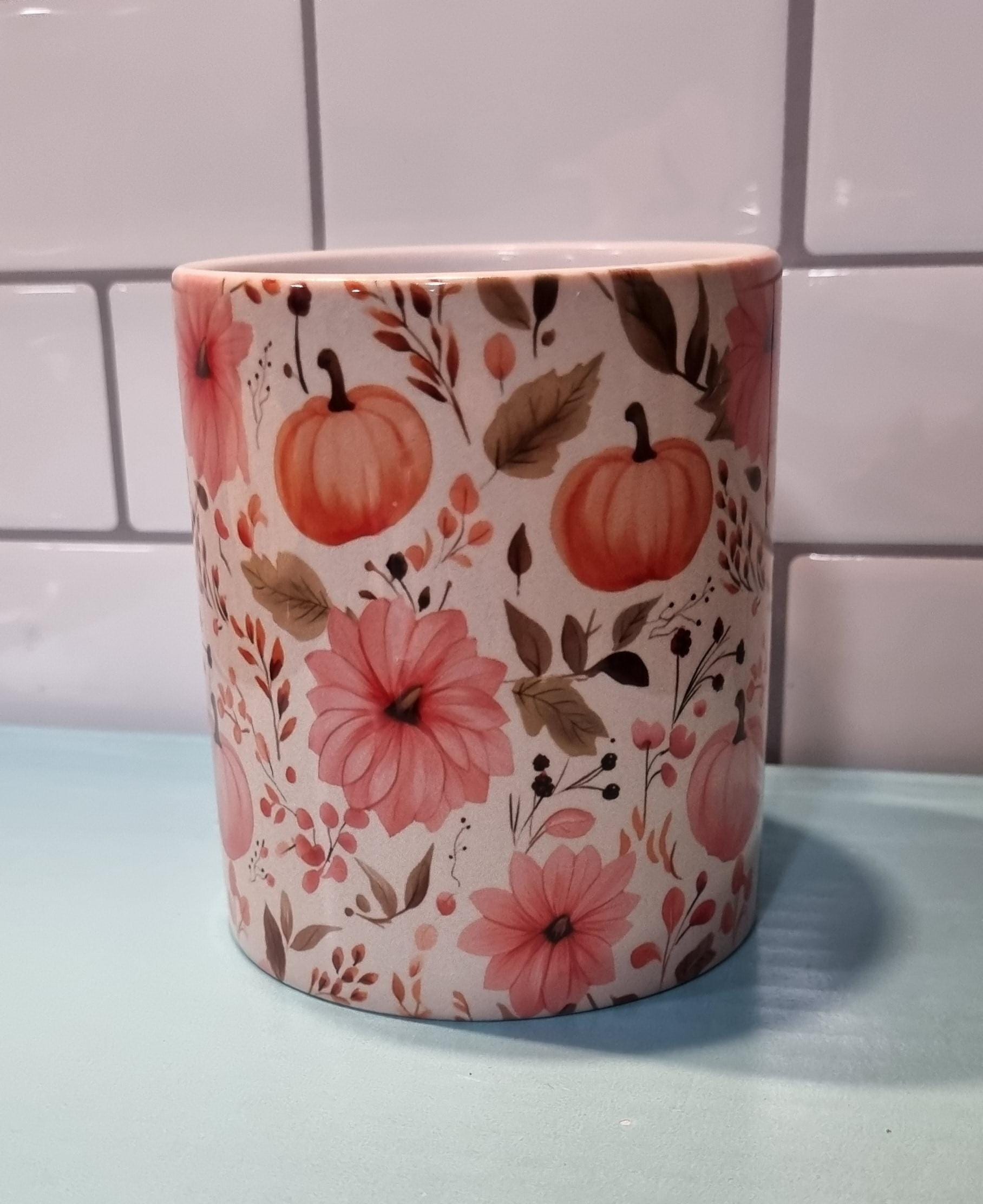 Ceramic pumpkin and flowers mug with autumn design featuring orange pumpkins and pink flowers