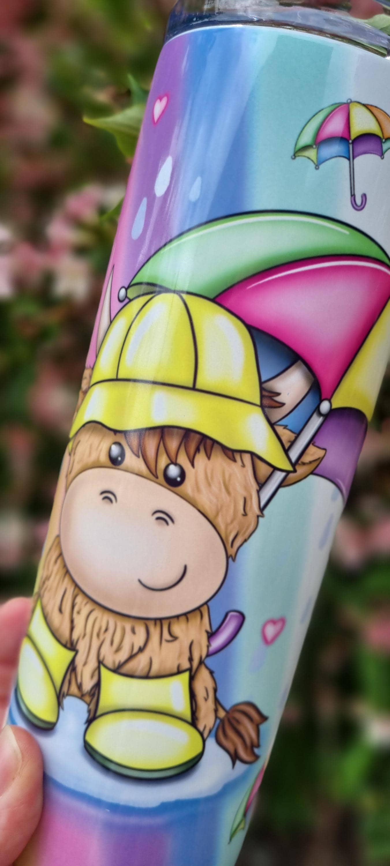 Rainbow highland cow tumbler with colourful umbrella and raincoat design in pastel colours