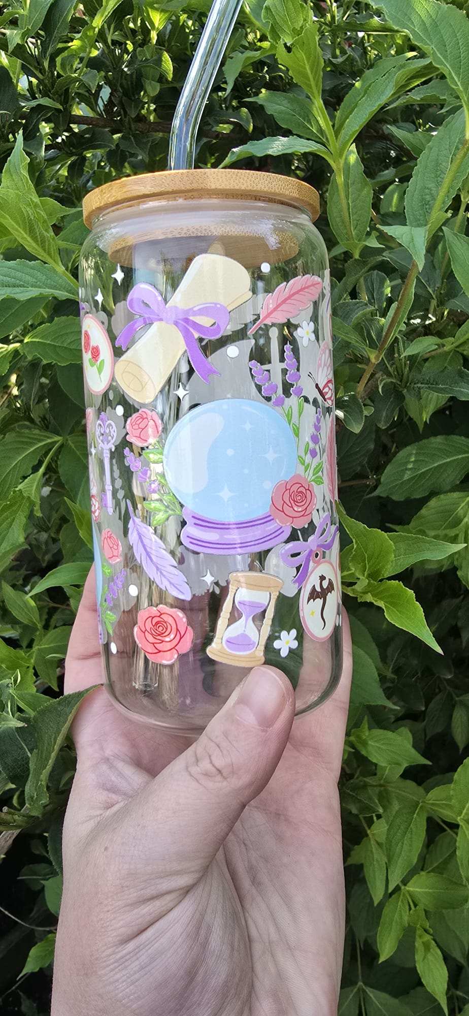 Sublimely Special romantasy book lover tumbler with crystal ball and floral design in hand outdoors