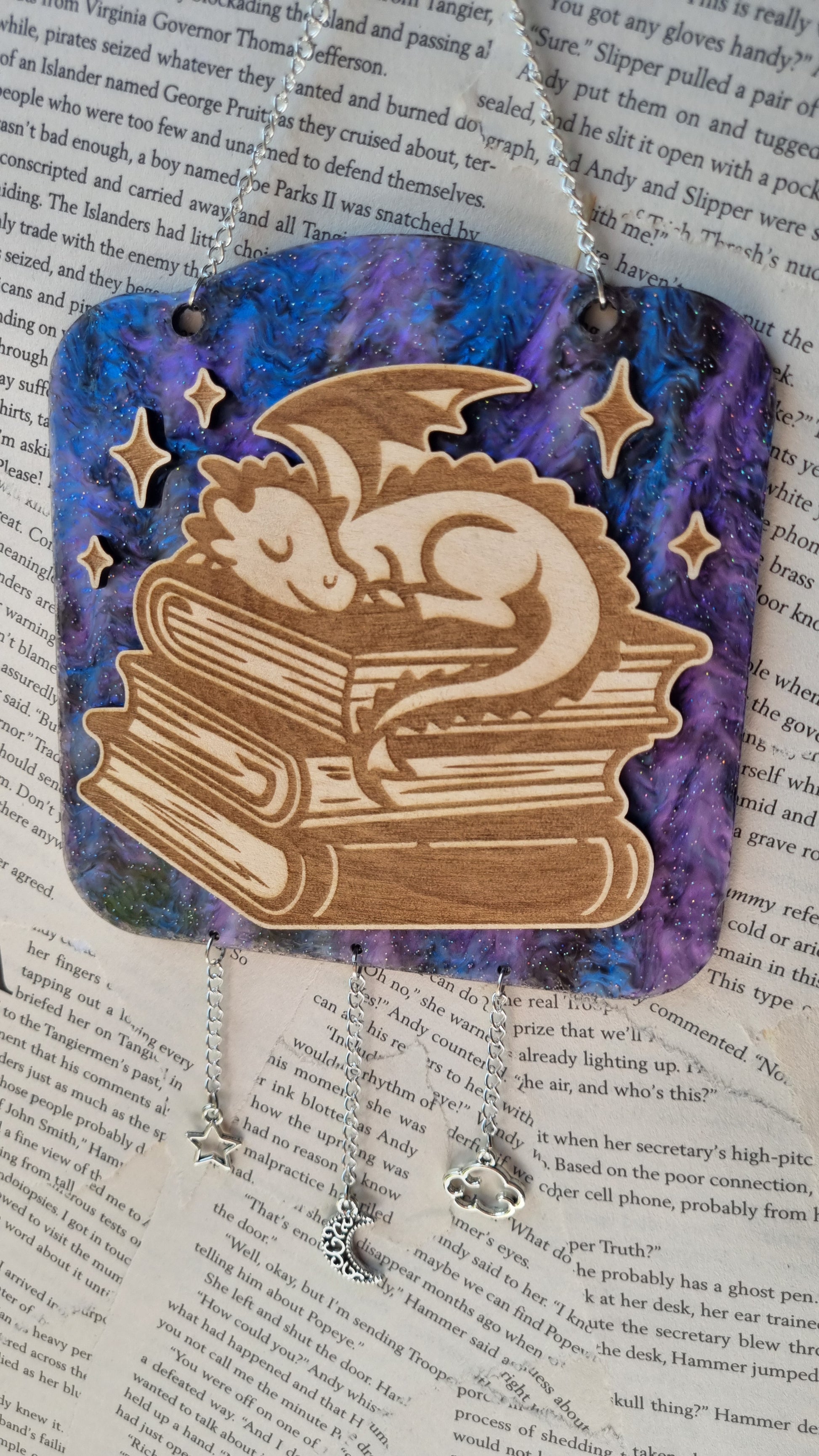 Sublimely Special sleepy dragon library ornament featuring a wooden dragon sleeping on stacked books with star decorations