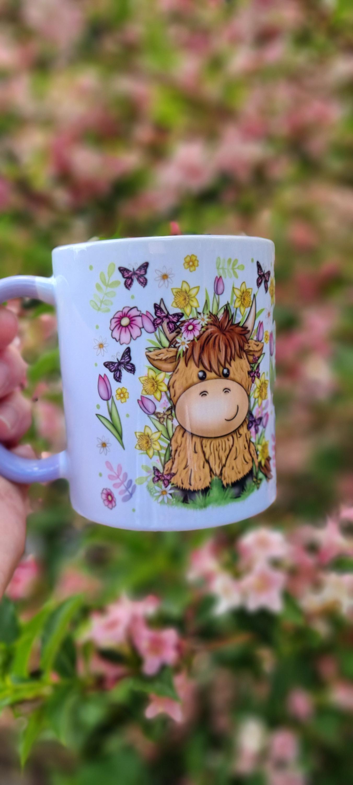 White spring cow coffee cup with cute cartoon cow surrounded by flowers and butterflies