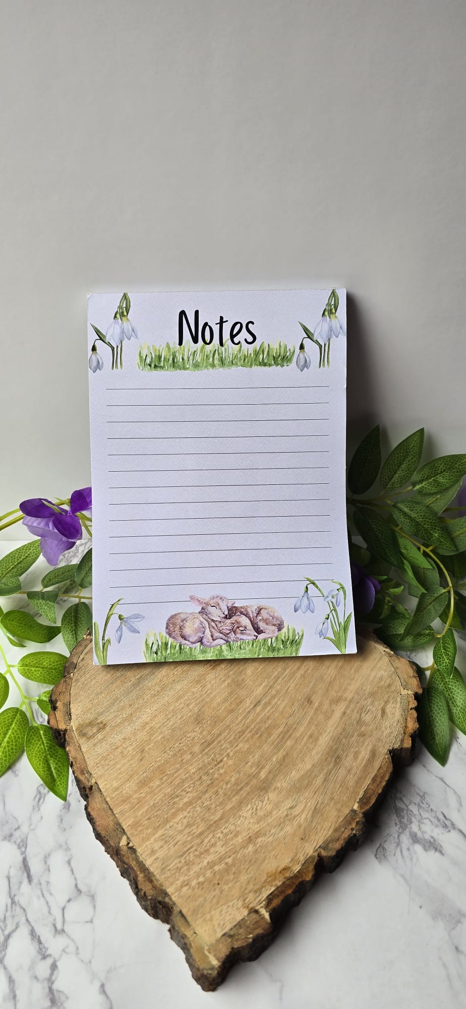 Sublimely Special spring lamb notepad with lined pages and floral design on wooden heart display