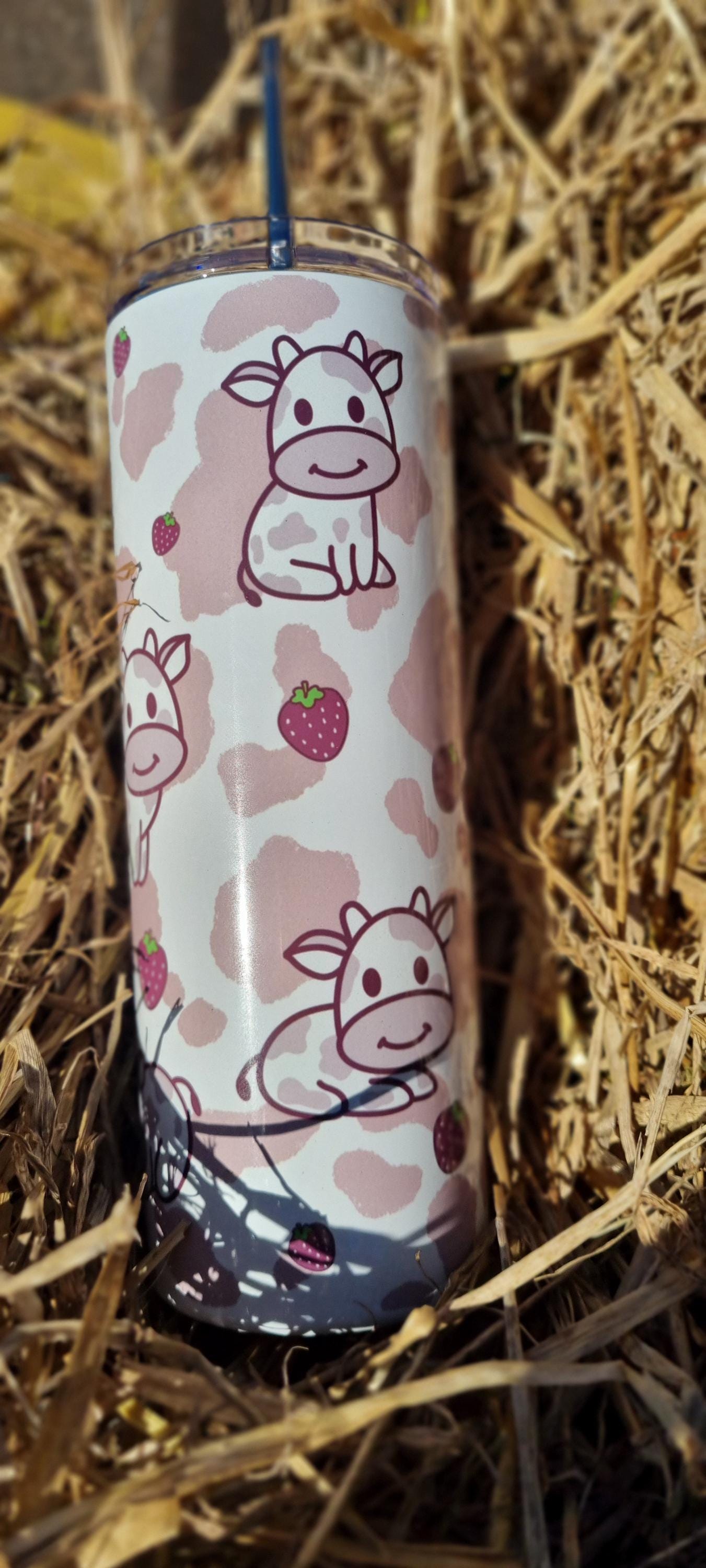 Strawberry cow tumbler with cute cow and strawberry design on light pink background