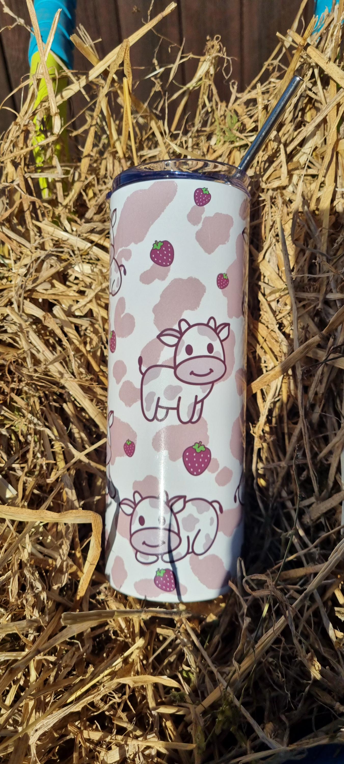 Strawberry cow tumbler with cute cow and strawberry pattern on dry grass background