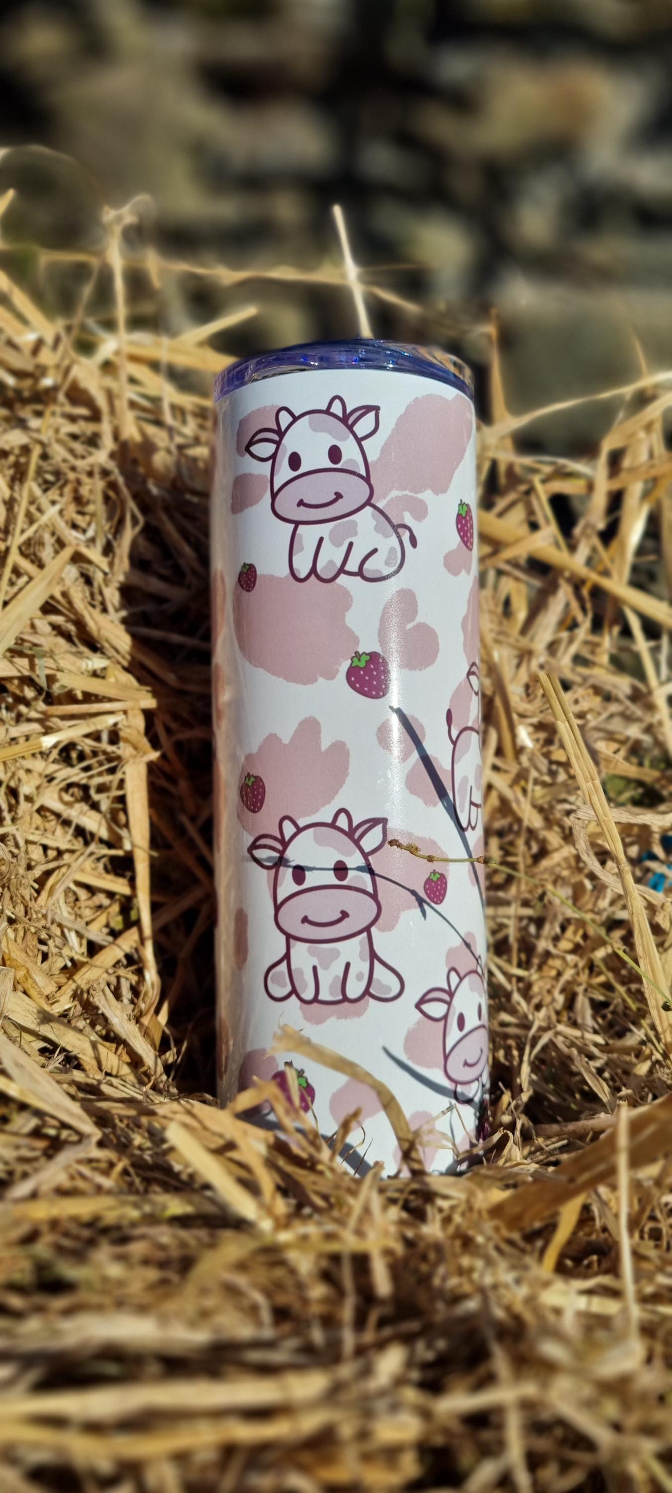 Strawberry cow tumbler with cute cow illustrations and strawberry patterns on a white background