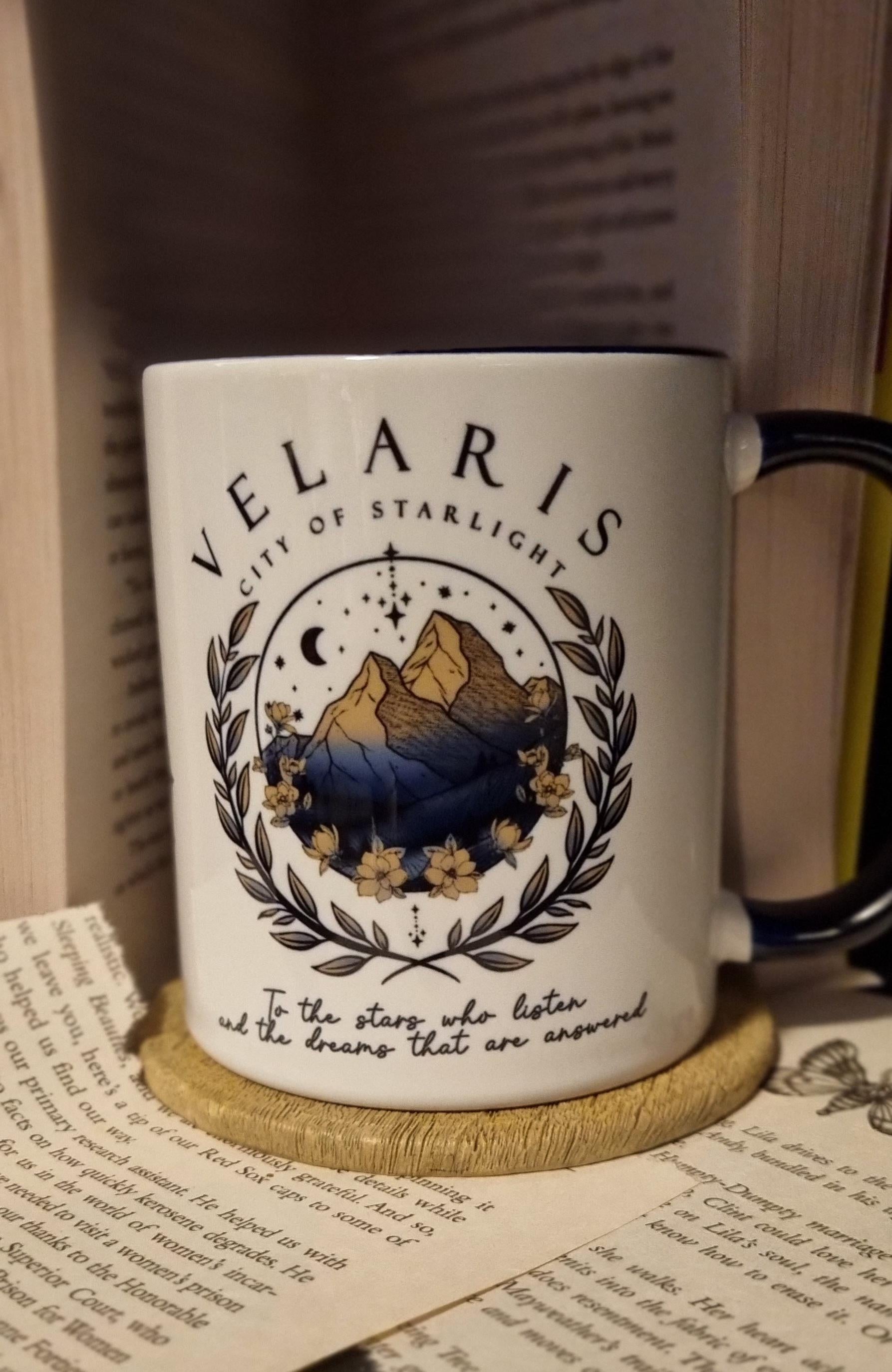 Velaris City of Starlight mug with mountain and star design on white ceramic cup with black handle
