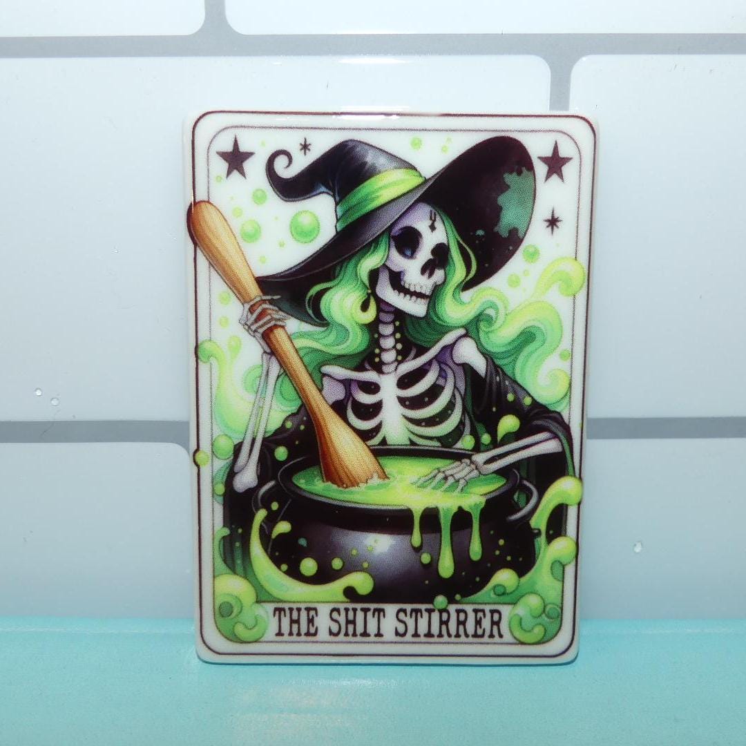 Witchy tarot fridge magnet featuring a skeleton witch stirring a glowing green potion cauldron