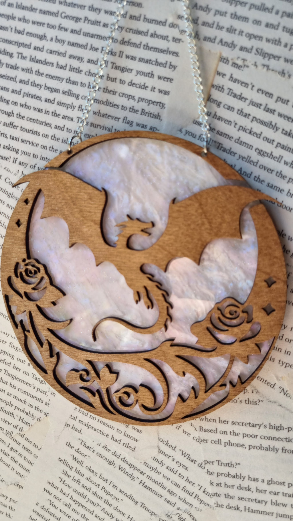 Whimsical dragon ornament for bookshelf made of intricately carved wood with floral details