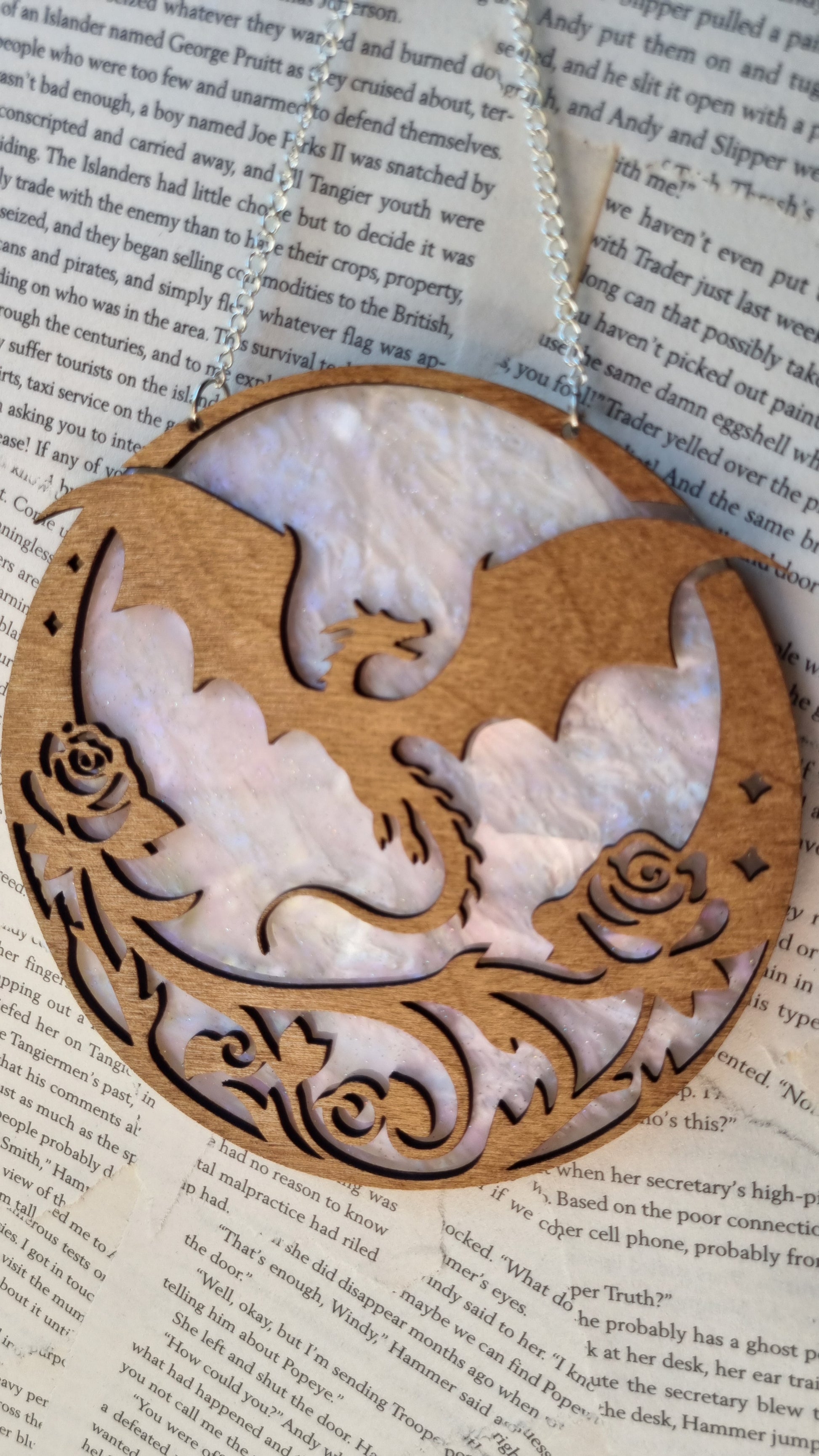 Whimsical dragon ornament for bookshelf made of intricately carved wood with floral details
